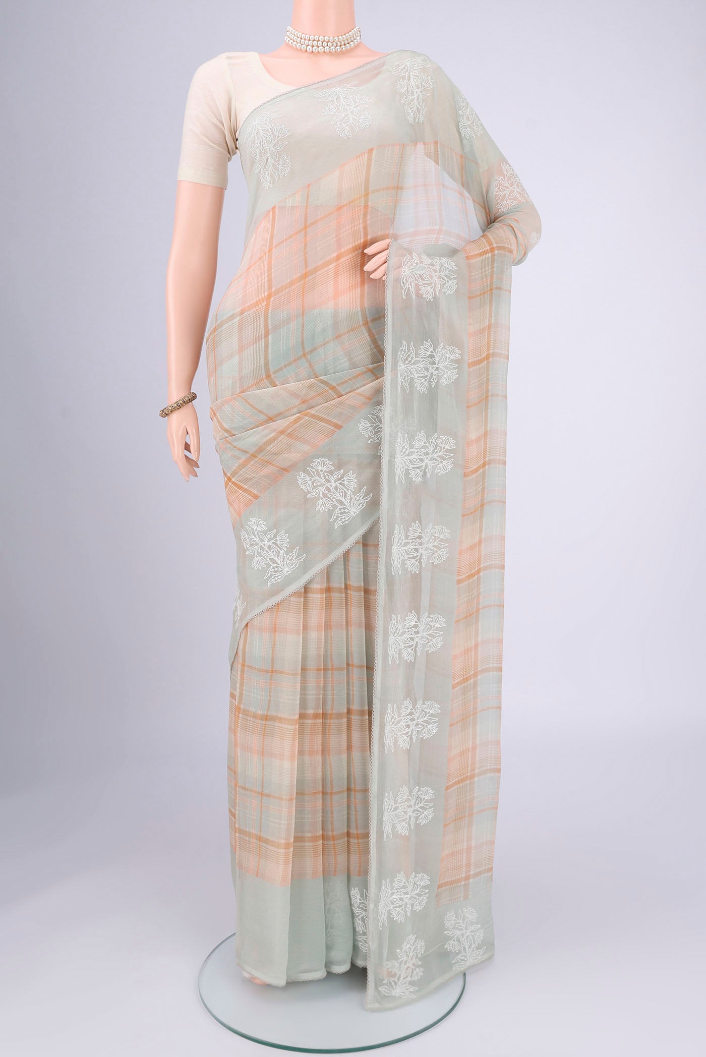 Sage Green Mysore Chiffon Saree with Checked design on the body and Thread Border.  displayed on a mannequin