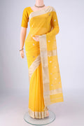Yellow Maheshwari Silk Cotton Saree with Zari Butta on the body and Zari Border.  displayed on a mannequin