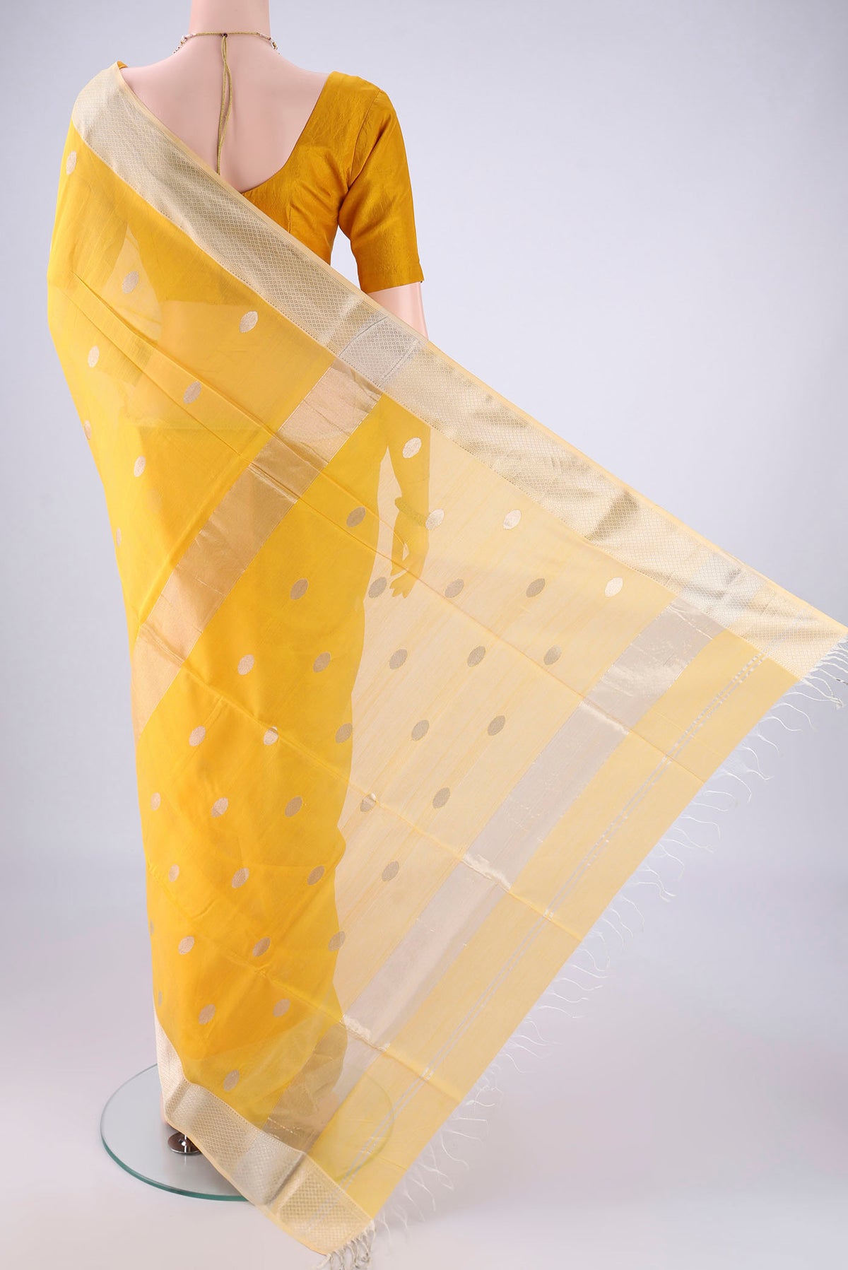 Flat view of Yellow Maheshwari Silk Cotton Saree with Zari Butta on the body and Zari Border. 