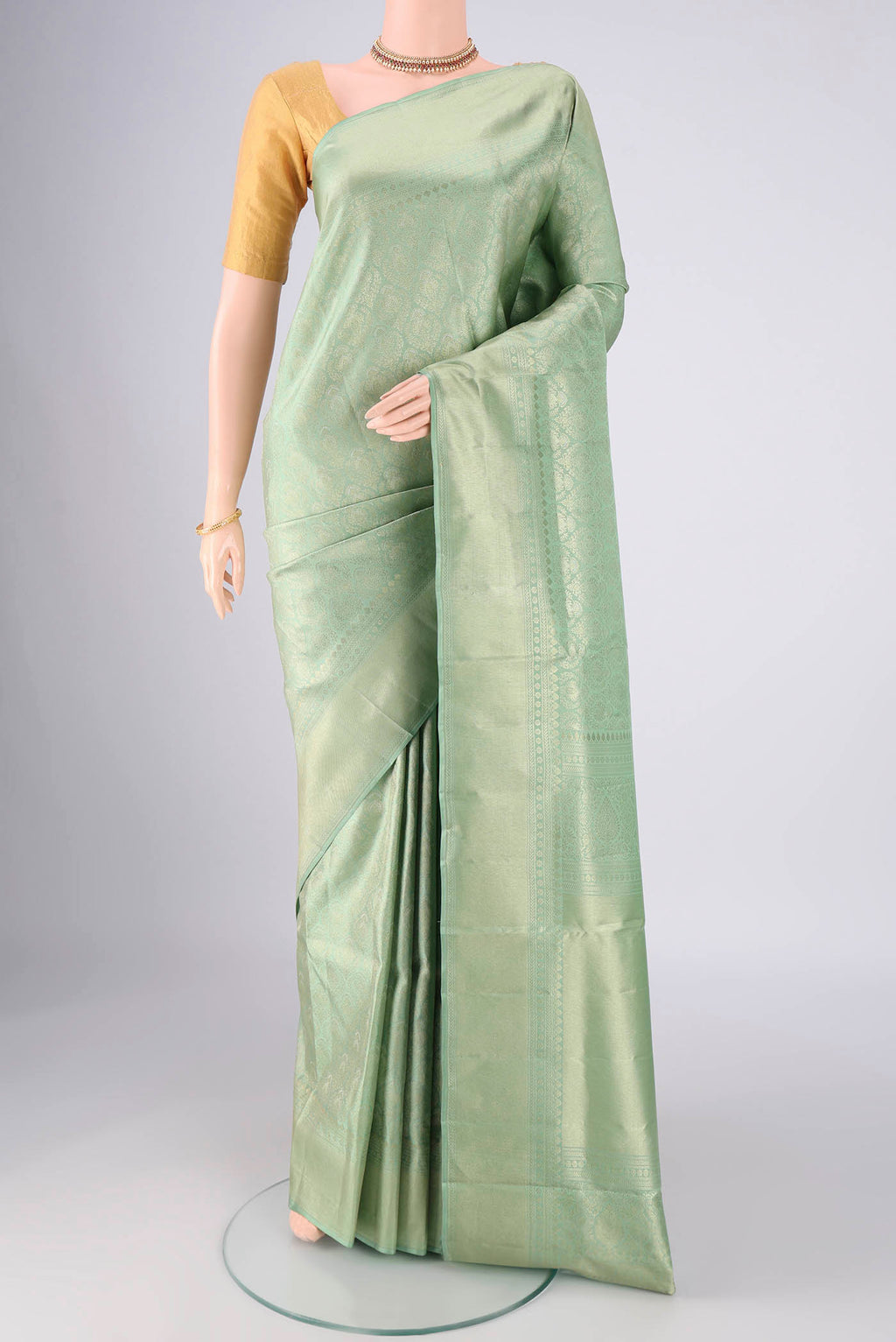 Mint Green Soft Silk Saree with Zari Butta on the body and Zari Border.  displayed on a mannequin