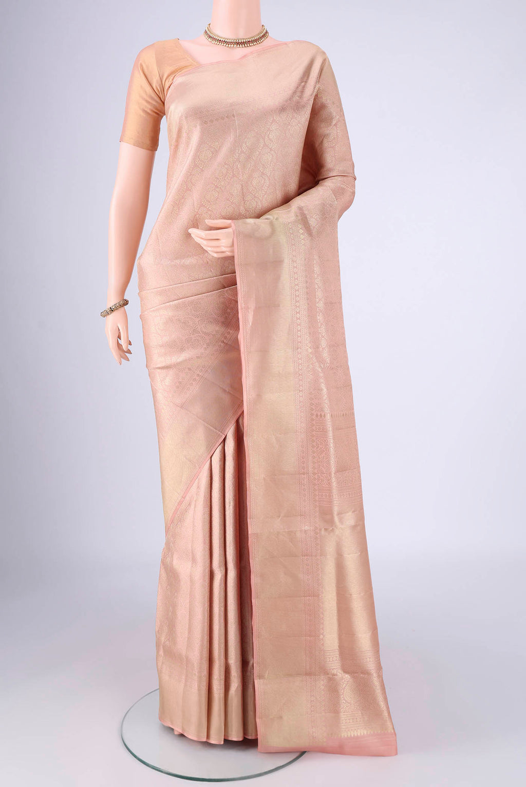 Rose Gold Soft Silk Saree with Zari Brocade on the body and Zari Border.  displayed on a mannequin