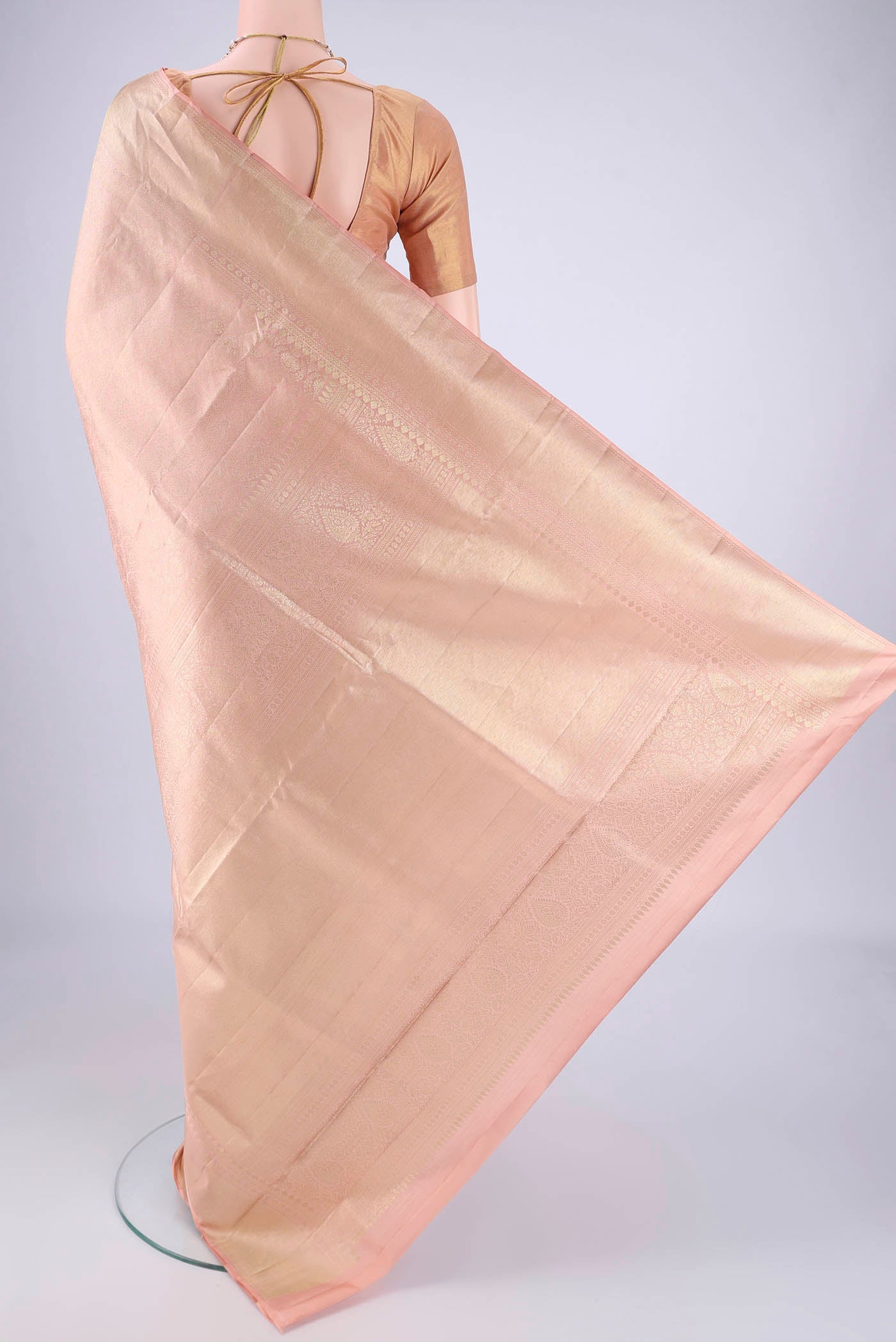 Flat view of Rose Gold Soft Silk Saree with Zari Brocade on the body and Zari Border. 