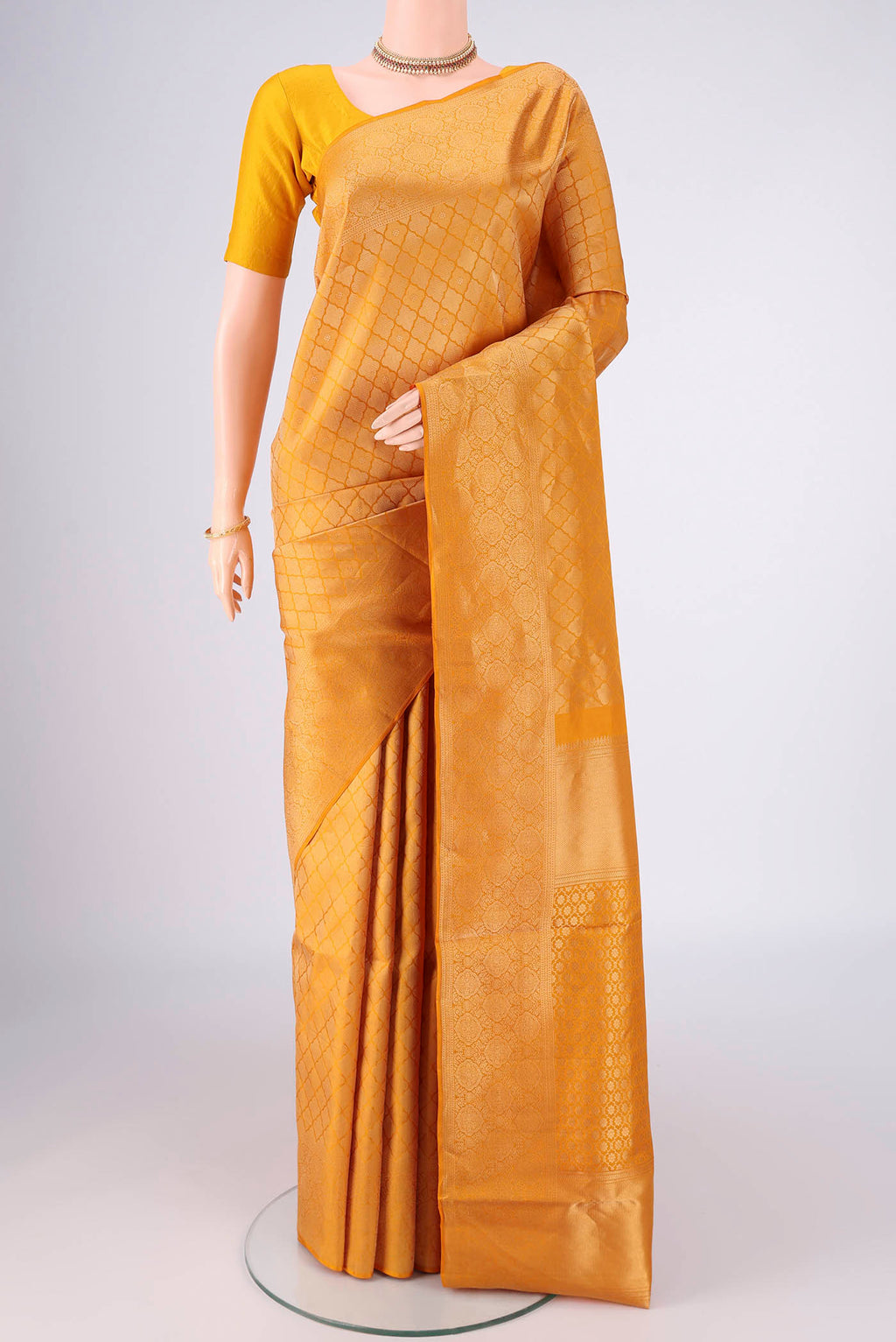 Yellow Soft Silk Saree with Zari Brocade on the body and Zari Border.  displayed on a mannequin