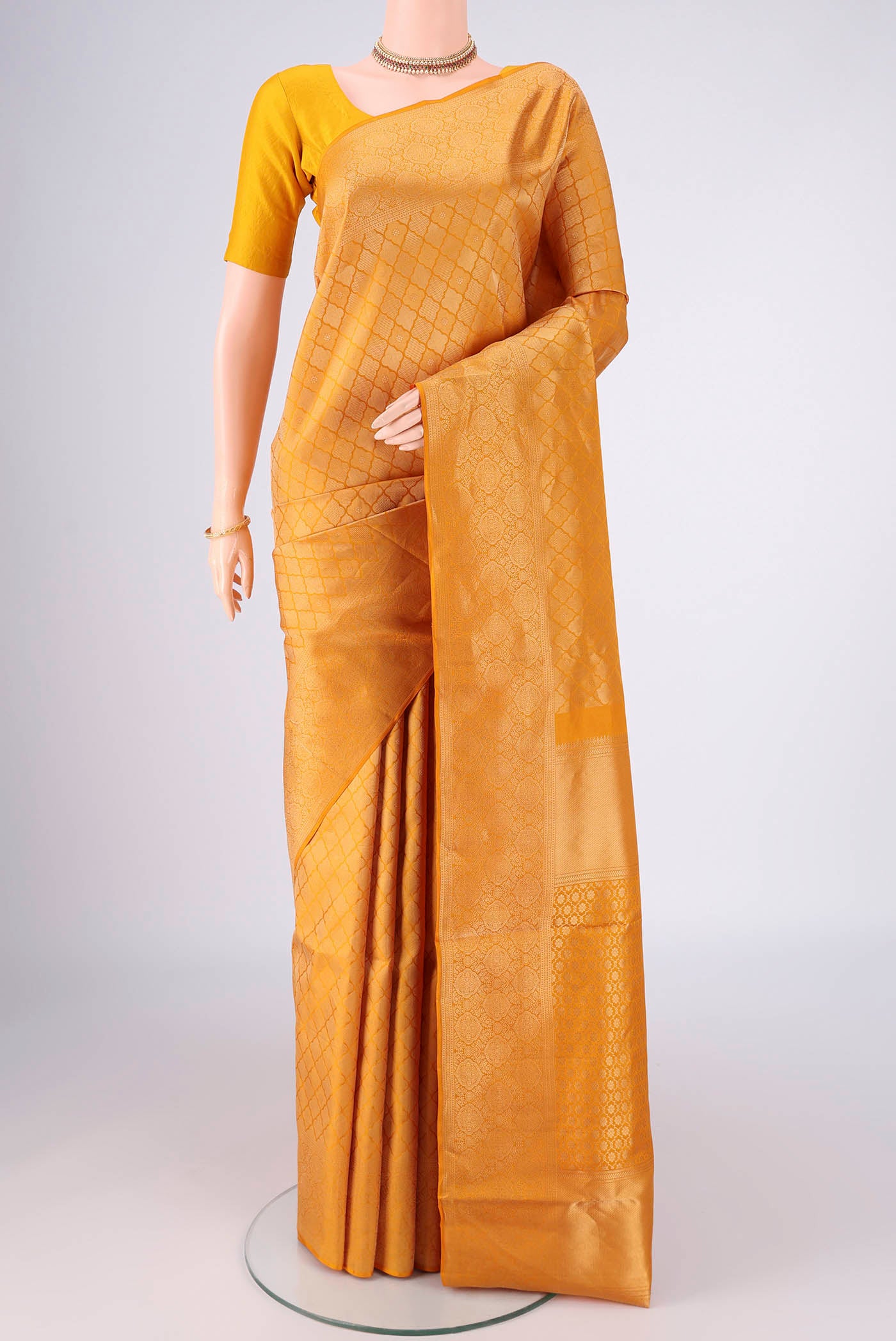 Yellow Soft Silk Saree with Zari Brocade on the body and Zari Border.  displayed on a mannequin