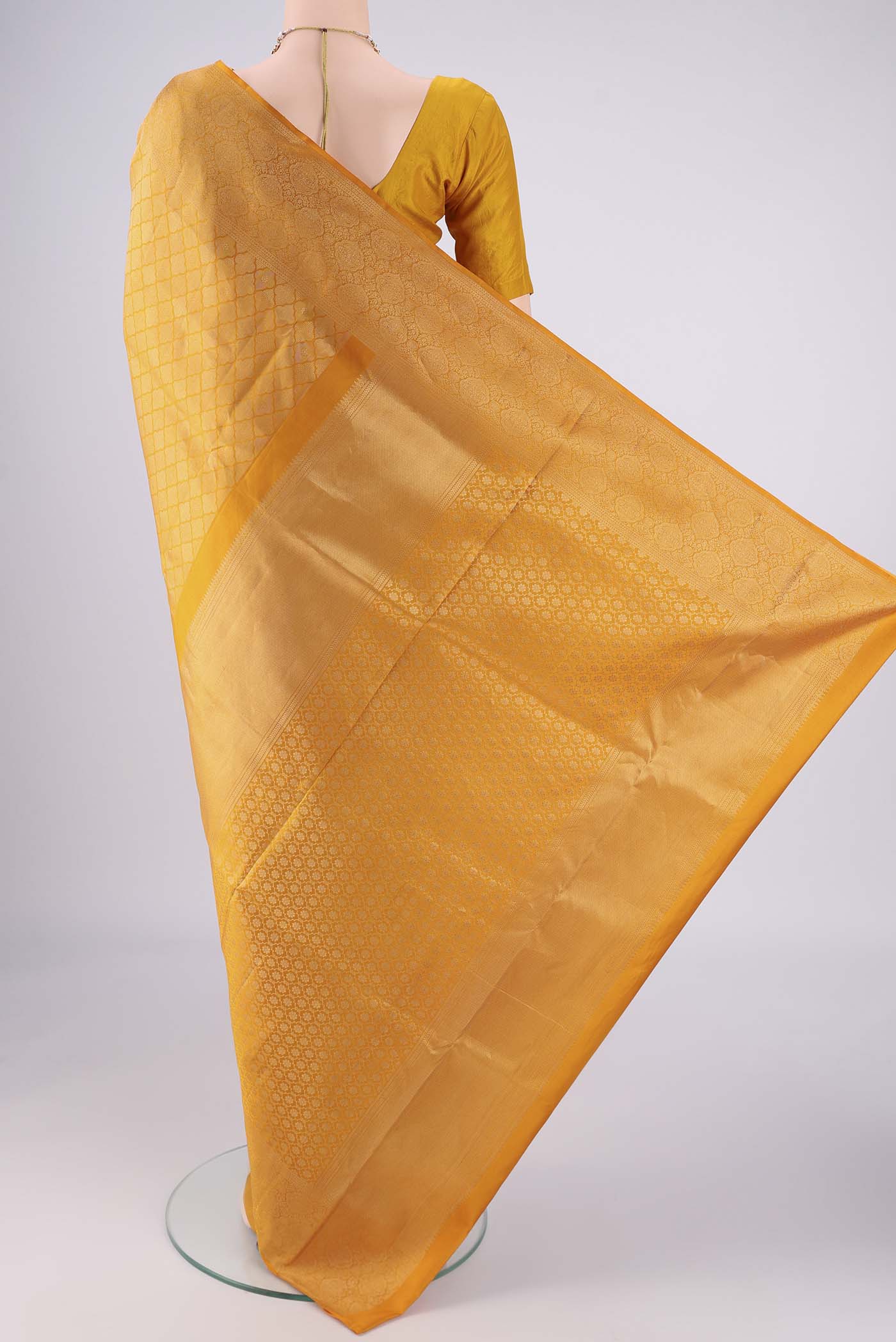 Flat view of Yellow Soft Silk Saree with Zari Brocade on the body and Zari Border. 