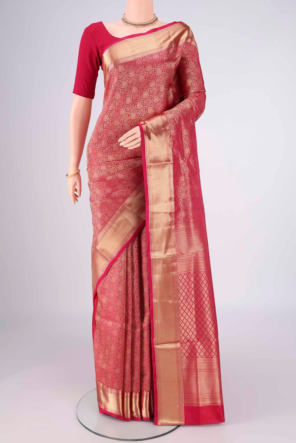 Rani Pink Soft Silk Saree with Zari Brocade on the body and Zari Border.  displayed on a mannequin