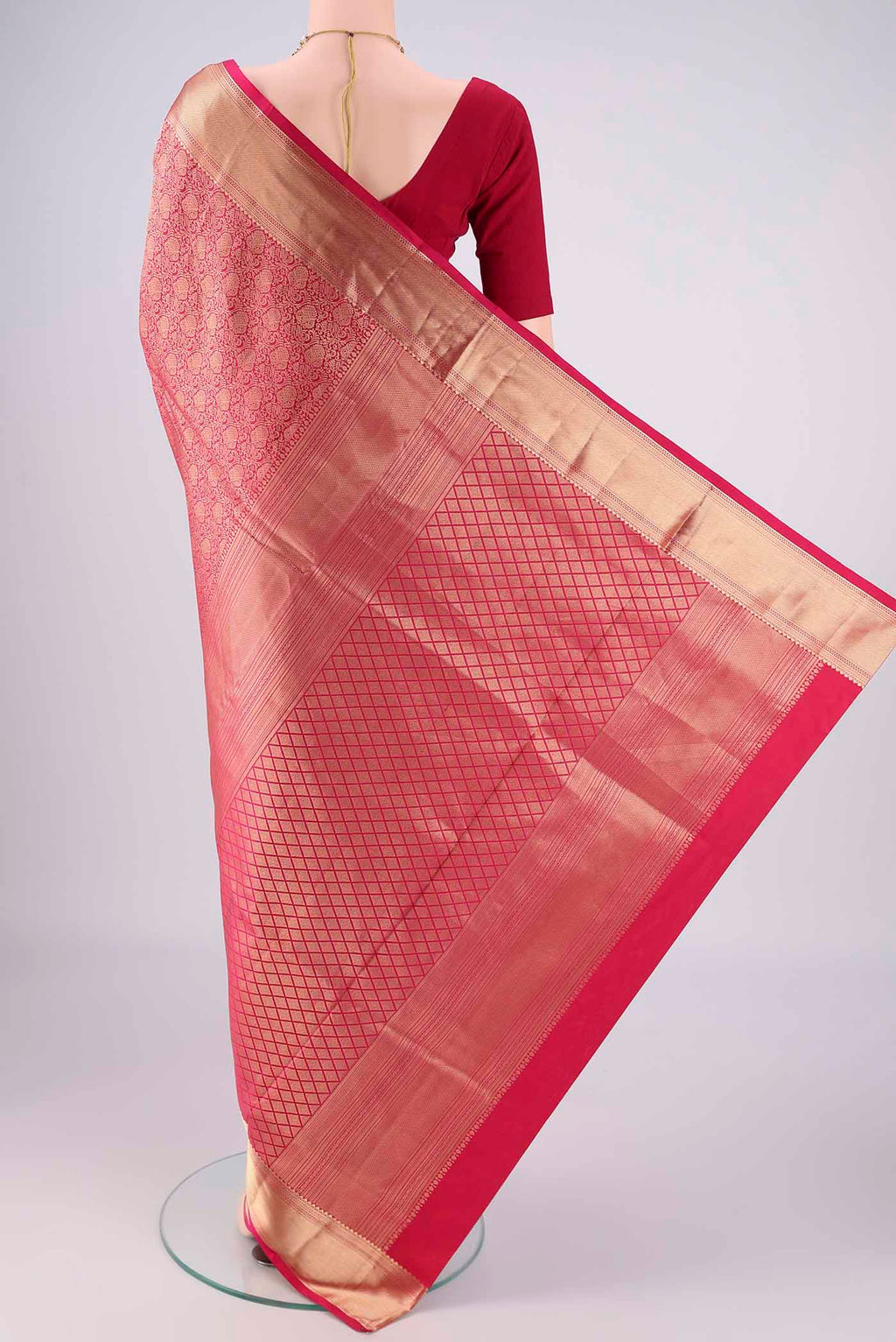 Flat view of Rani Pink Soft Silk Saree with Zari Brocade on the body and Zari Border. 