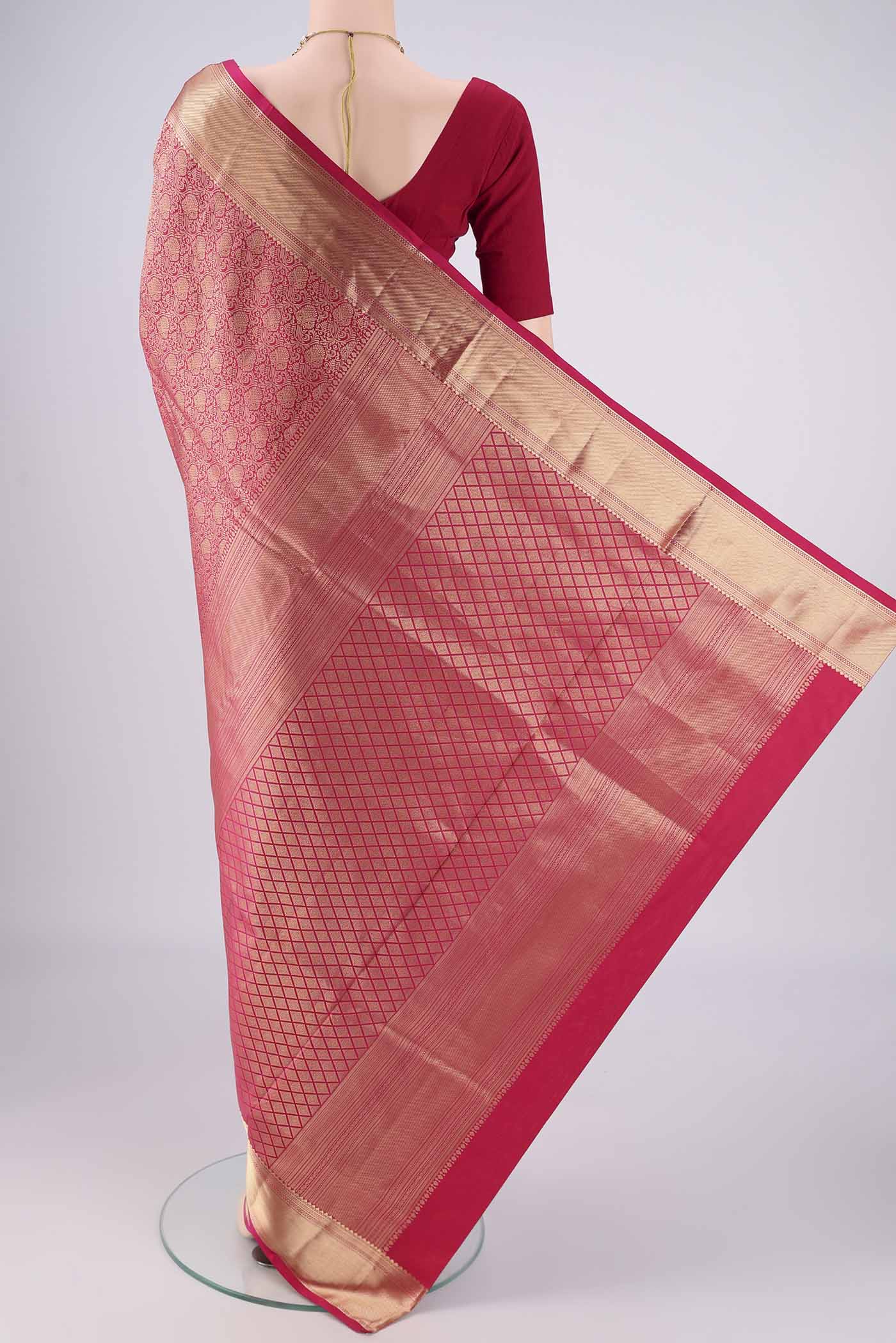 Flat view of Rani Pink Soft Silk Saree with Zari Brocade on the body and Zari Border. 