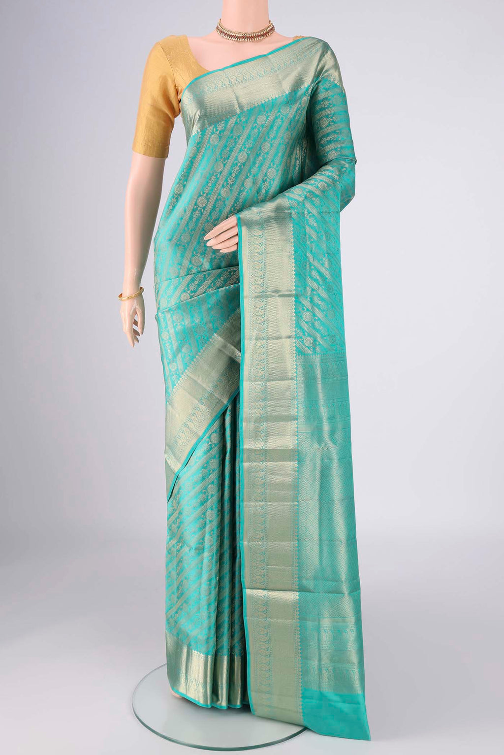 Turquoise Soft Silk Saree with Zari Brocade on the body and Zari Border.  displayed on a mannequin
