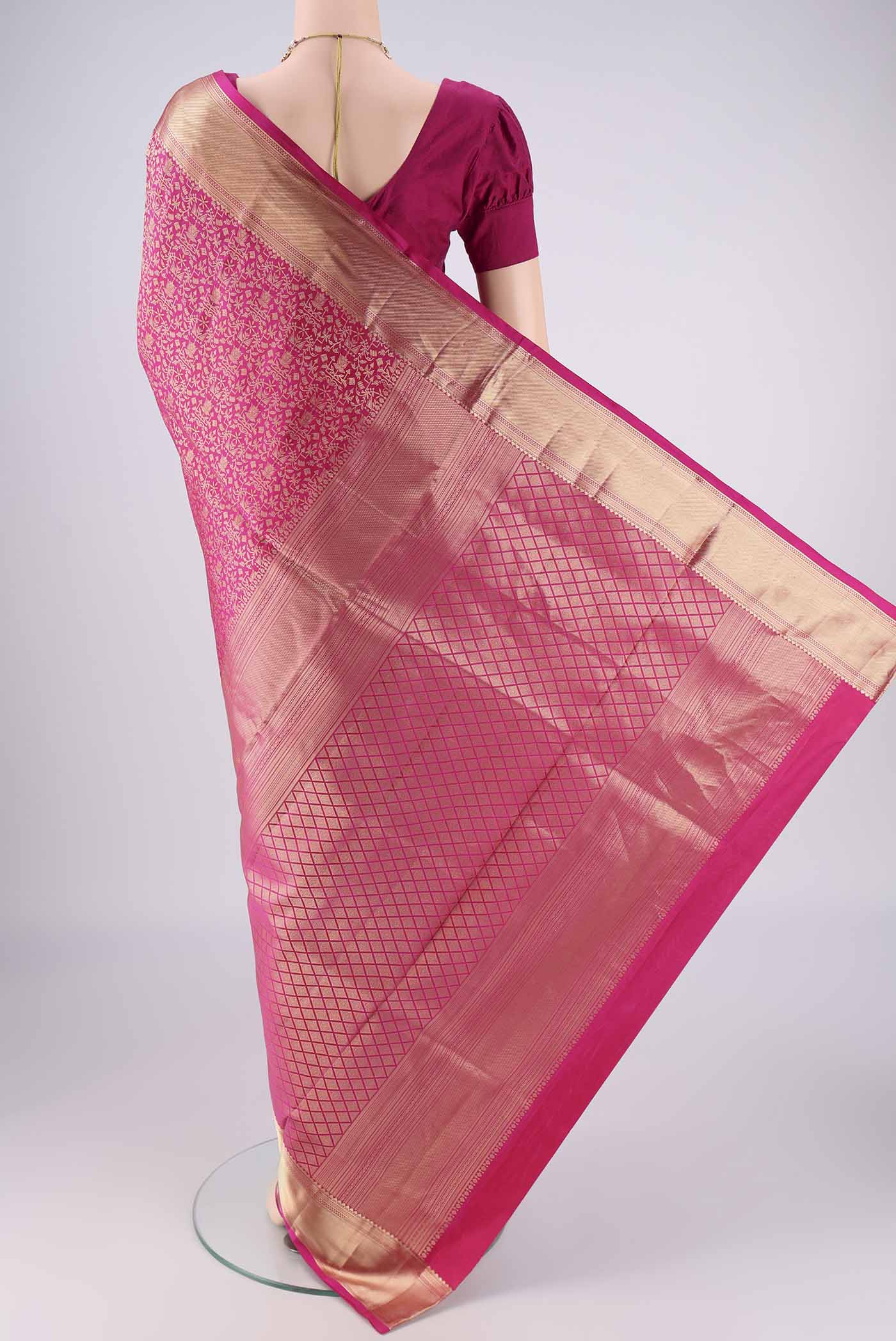 Flat view of Rani Pink Soft Silk Saree with Zari Brocade on the body and Zari Border. 
