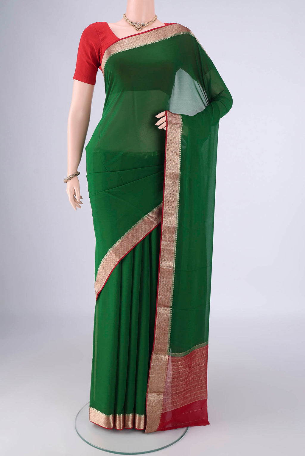 Bottle Green Mysore Crepe Saree with Plain Body and Zari Border.  displayed on a mannequin