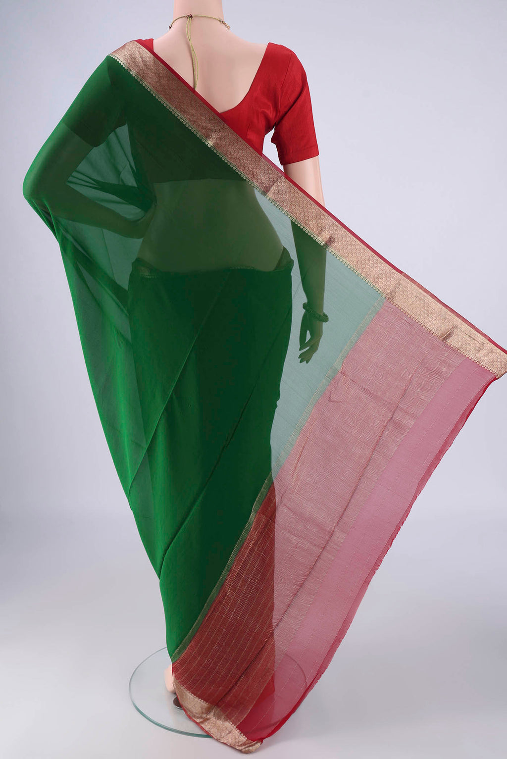 Flat view of Bottle Green Mysore Crepe Saree with Plain Body and Zari Border. 
