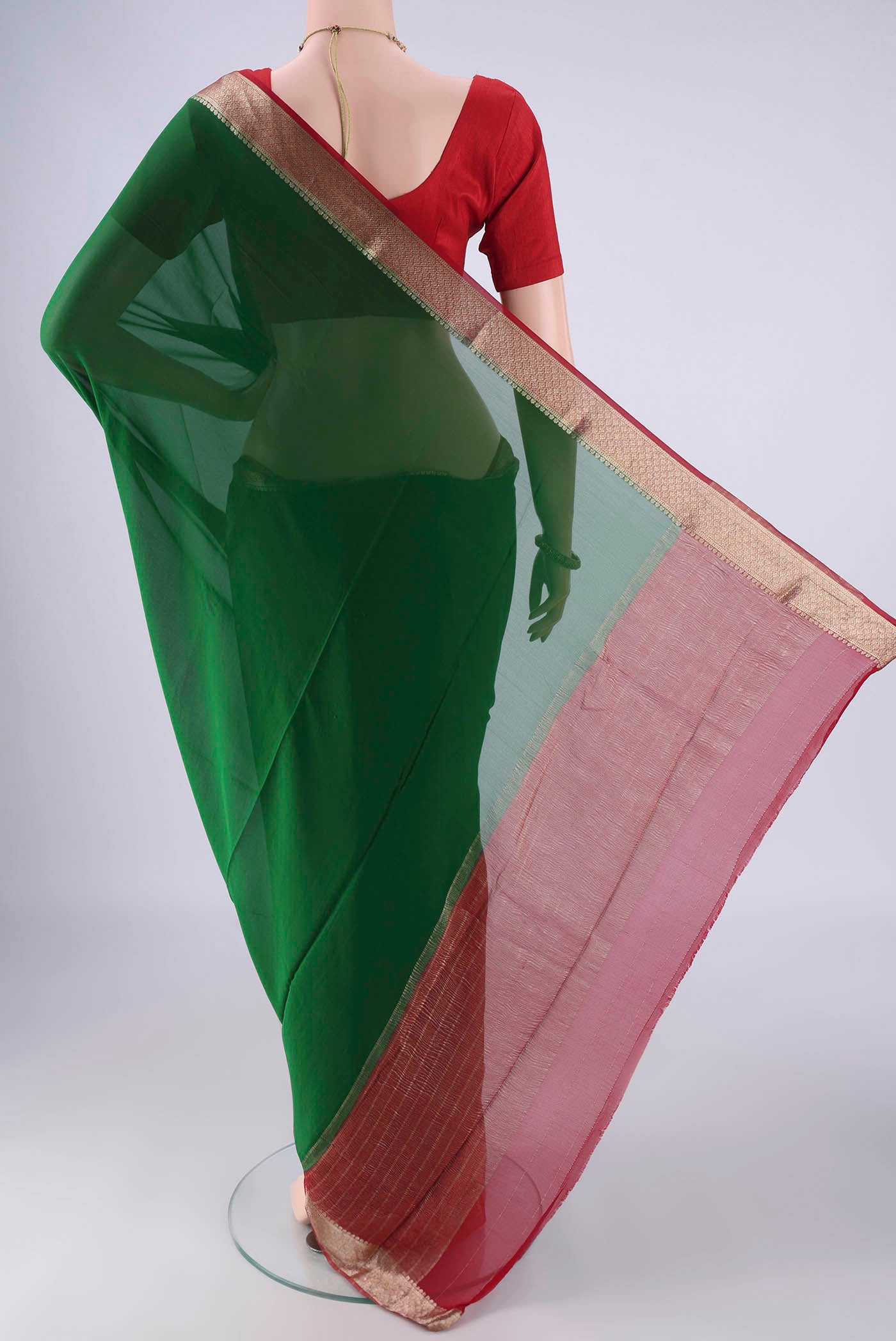Flat view of Bottle Green Mysore Crepe Saree with Plain Body and Zari Border. 