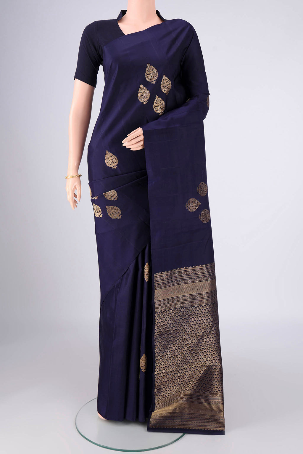 Navy Blue Soft Silk Saree with Zari Butta on the body and Without Border.  displayed on a mannequin