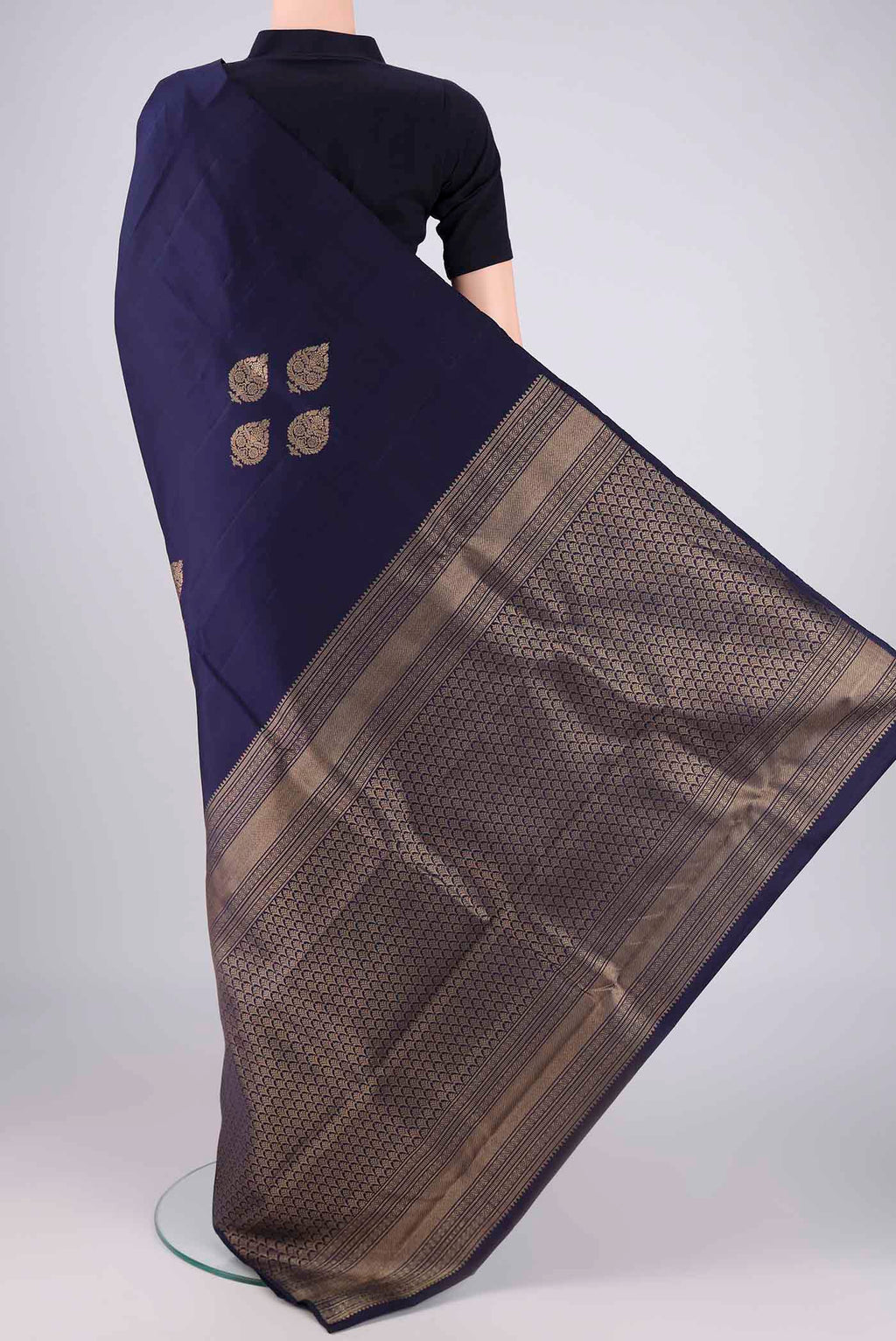 Flat view of Navy Blue Soft Silk Saree with Zari Butta on the body and Without Border. 