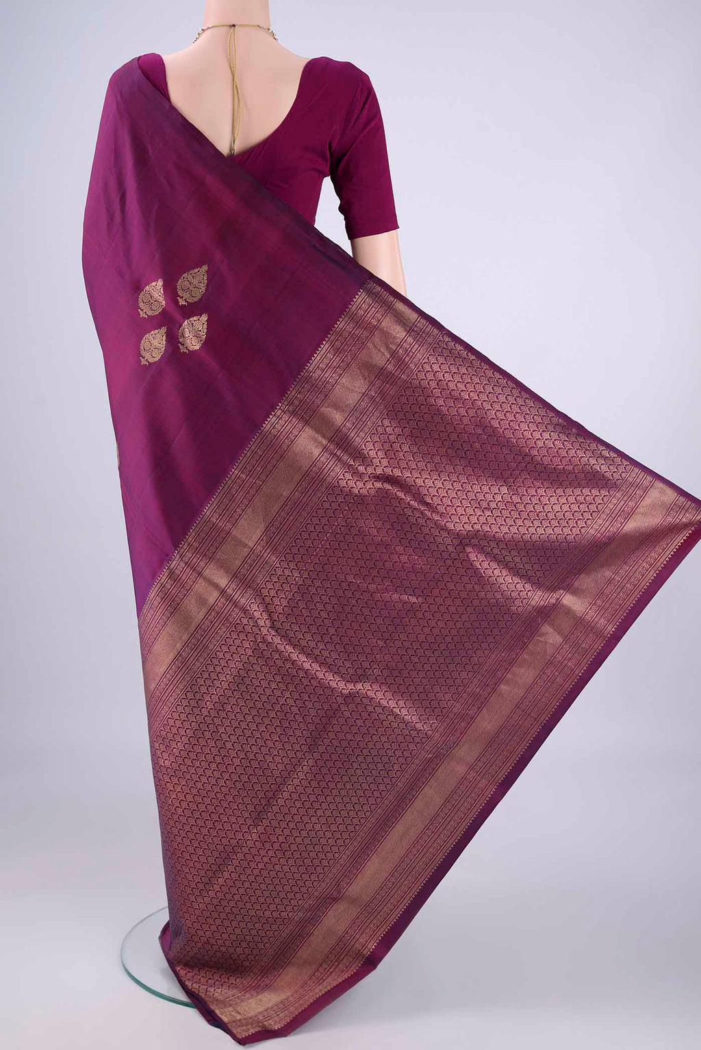 Flat view of Purple Soft Silk Saree with Zari Butta on the body and Without Border. 