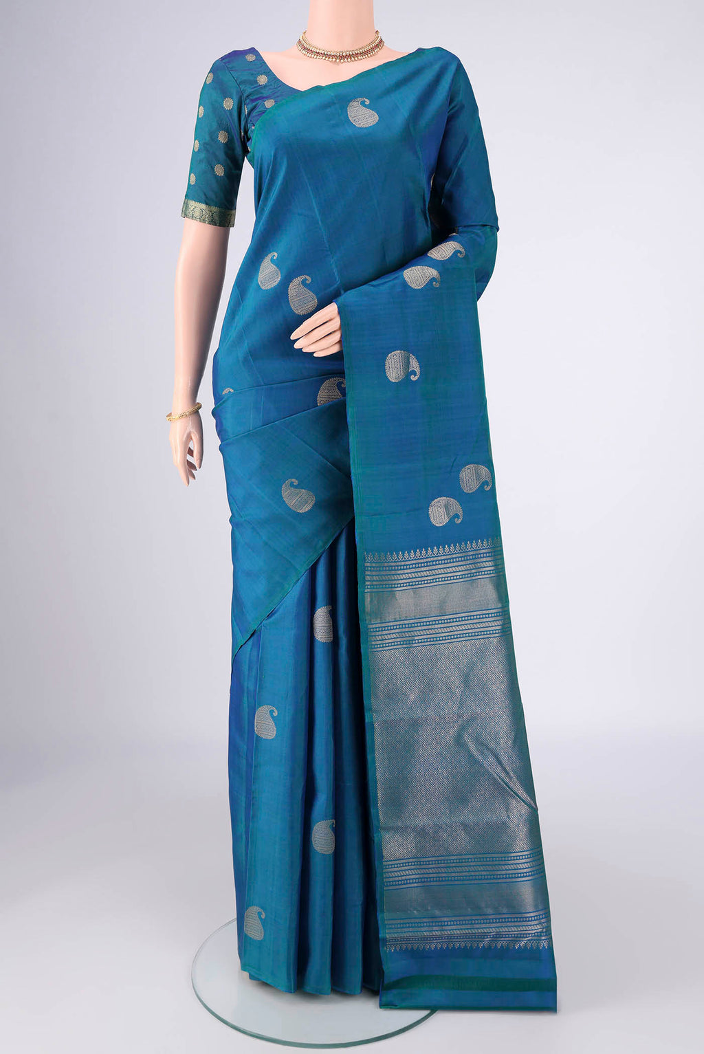 Peacock Blue Dual Tone Soft Silk Saree with Zari Butta on the body and Without Border.  displayed on a mannequin