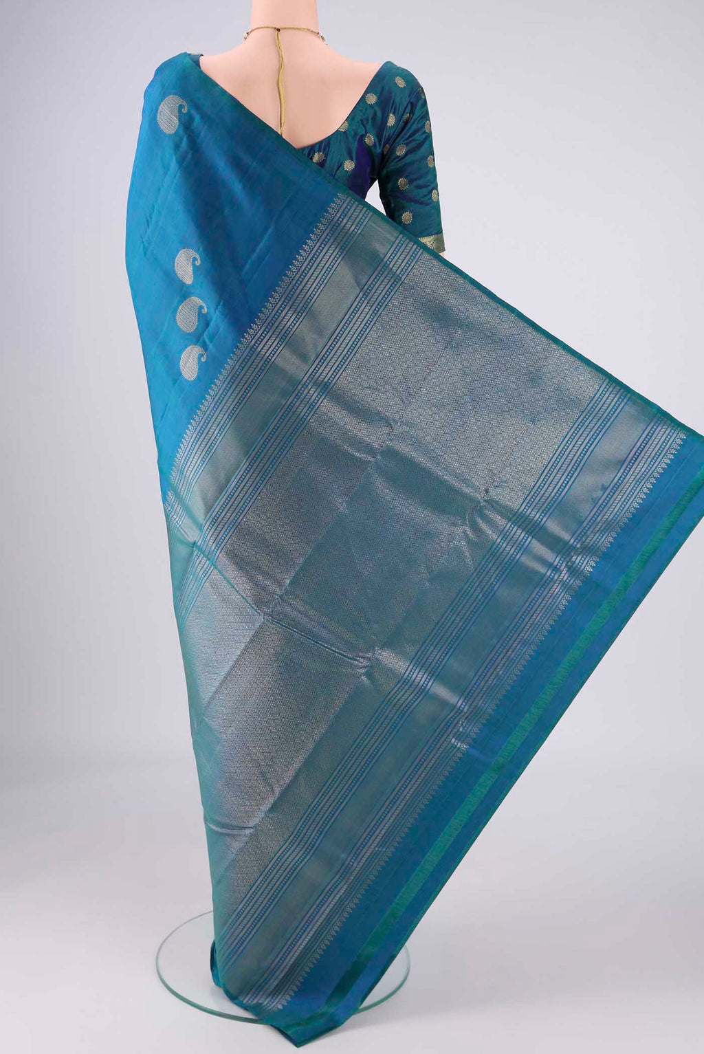 Flat view of Peacock Blue Dual Tone Soft Silk Saree with Zari Butta on the body and Without Border. 