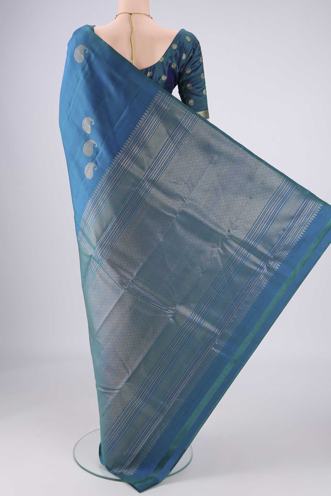 Flat view of Peacock Blue Dual Tone Soft Silk Saree with Zari Butta on the body and Without Border. 