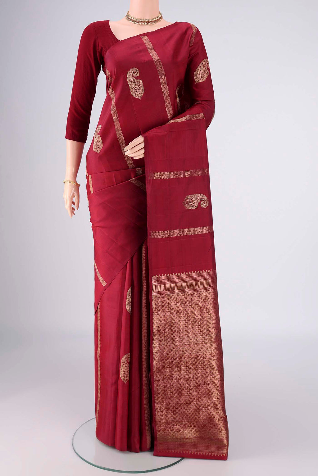 Maroon Soft Silk Saree with Zari Butta on the body and Without Border.  displayed on a mannequin