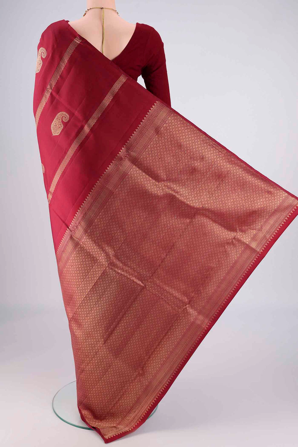 Flat view of Maroon Soft Silk Saree with Zari Butta on the body and Without Border. 