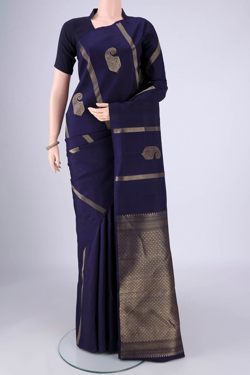 Navy Blue Soft Silk Saree with Zari Butta on the body and Without Border.  displayed on a mannequin