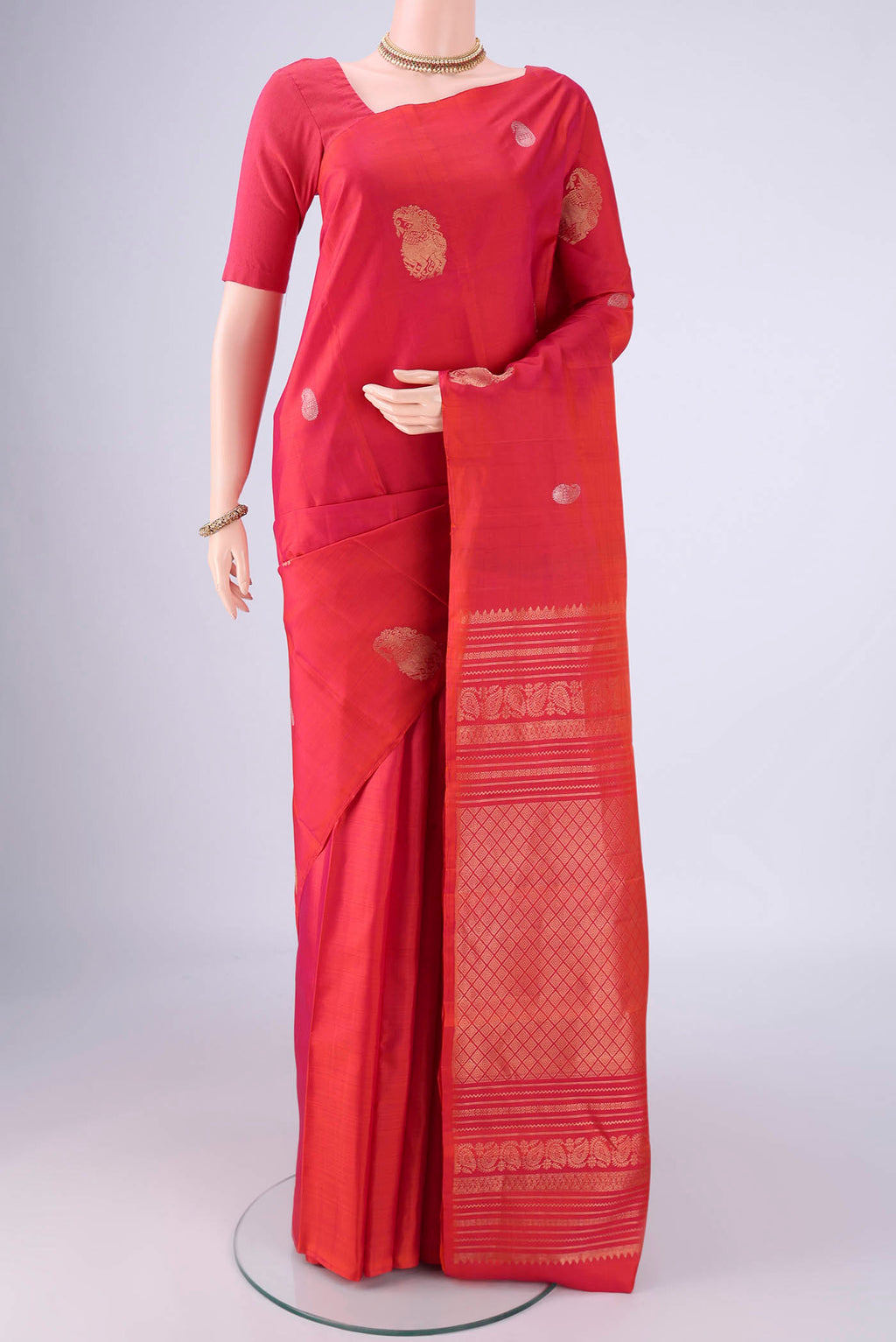 Coral Dual Tone Soft Silk Saree with Zari Butta on the body and Without Border.  displayed on a mannequin