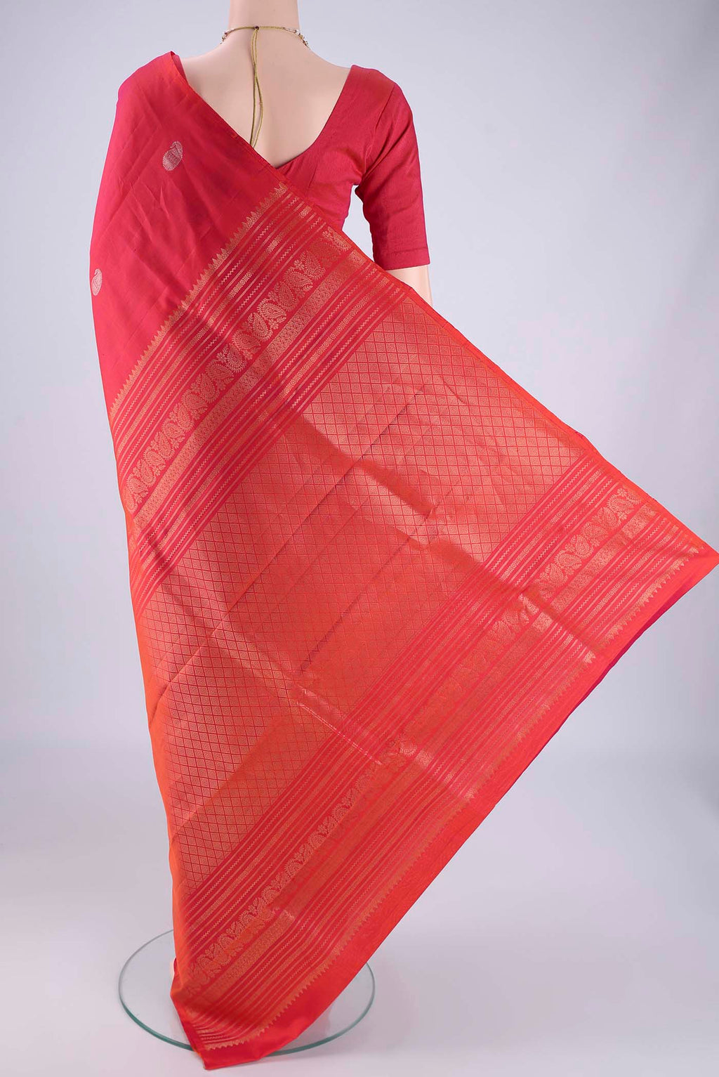 Flat view of Coral Dual Tone Soft Silk Saree with Zari Butta on the body and Without Border. 