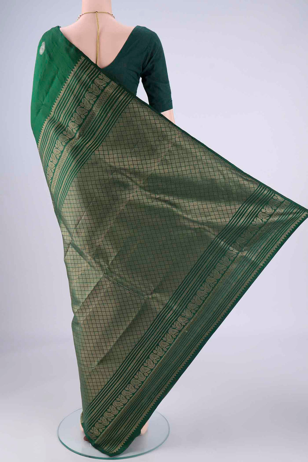 Flat view of Bottle Green Soft Silk Saree with Zari Butta on the body and Plain Border. 