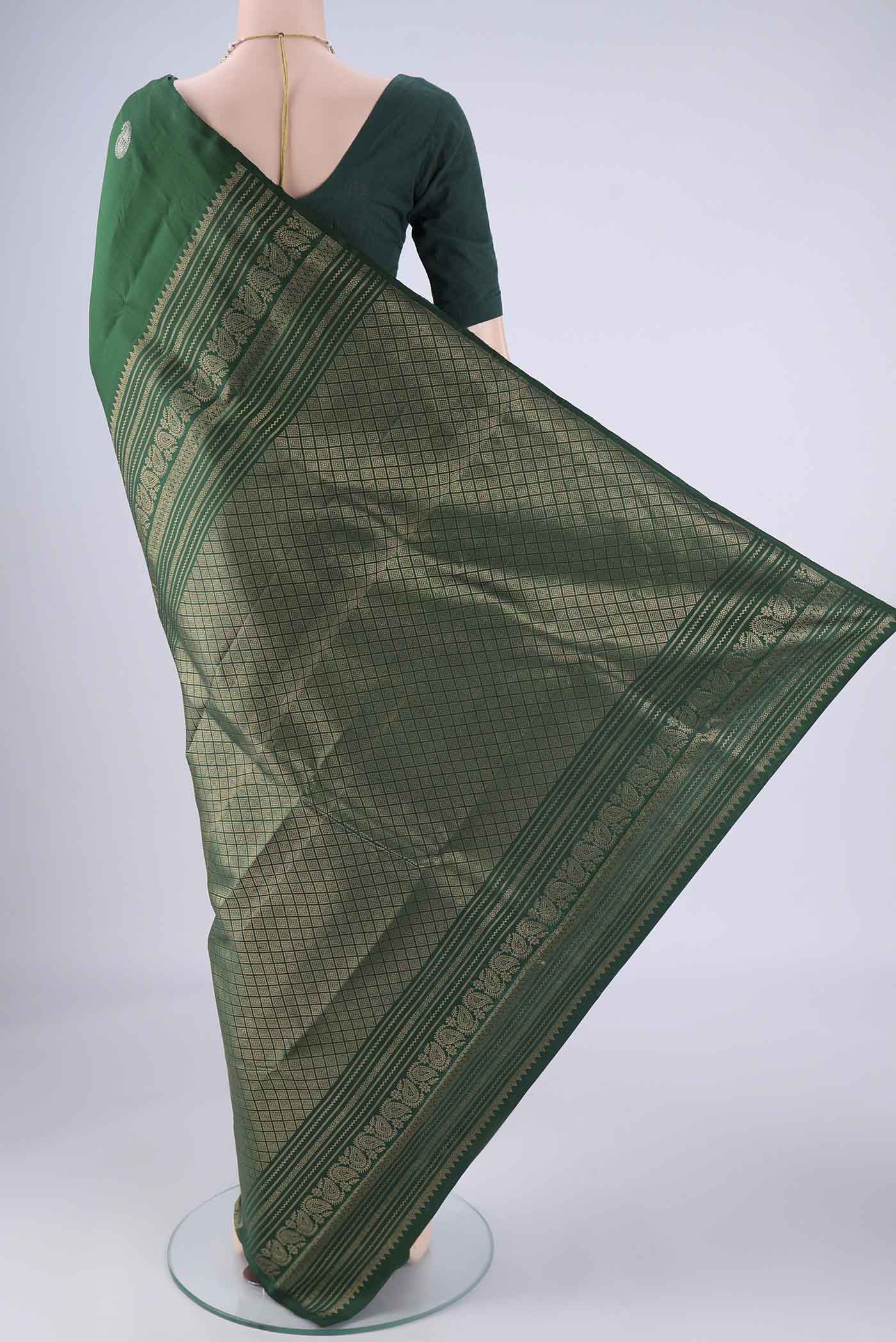 Flat view of Bottle Green Soft Silk Saree with Zari Butta on the body and Plain Border. 