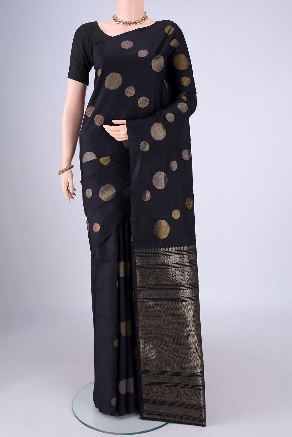 Navy Blue Soft Silk Saree with Zari Butta on the body and Without Border.  displayed on a mannequin