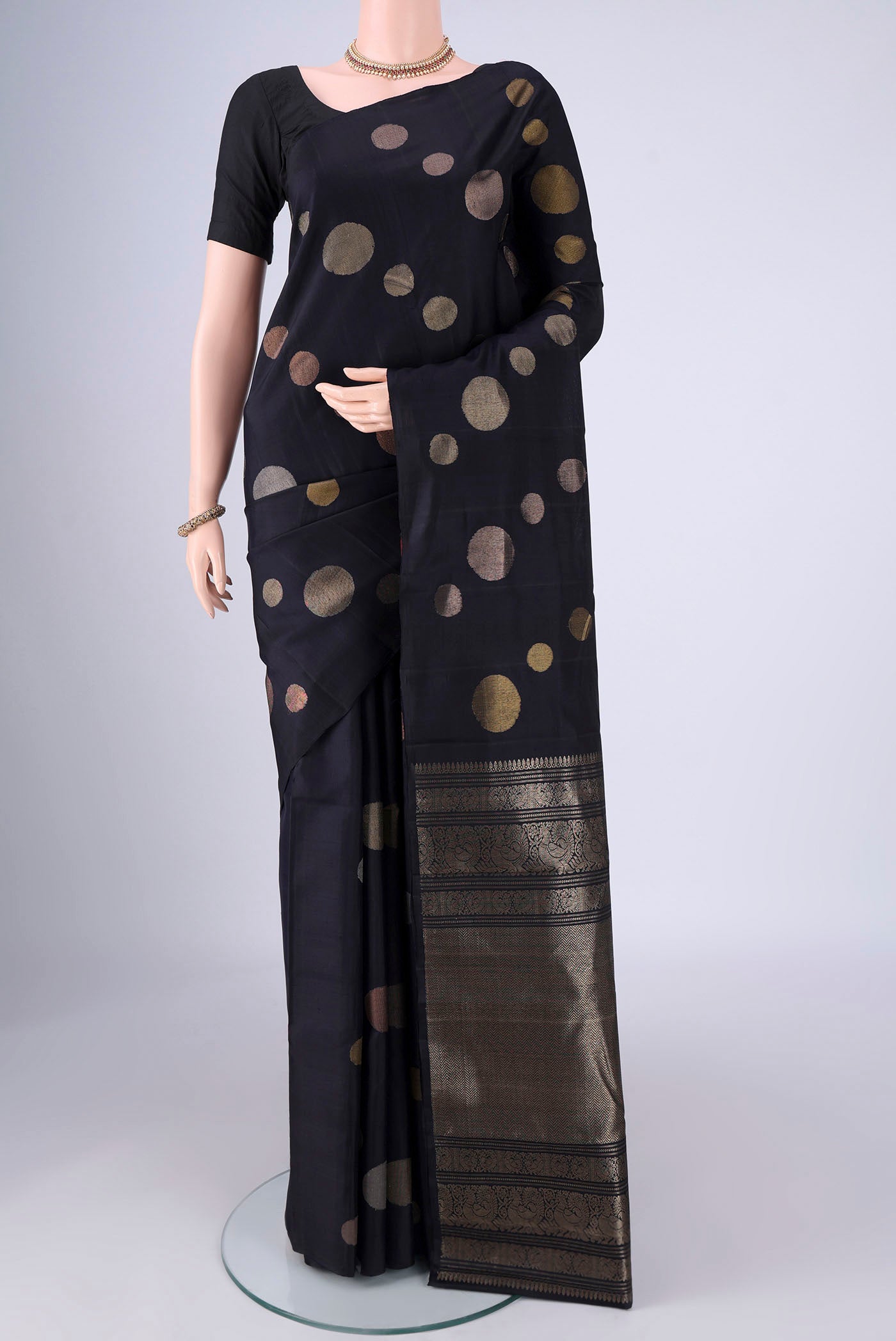 Navy Blue Soft Silk Saree with Zari Butta on the body and Without Border.  displayed on a mannequin