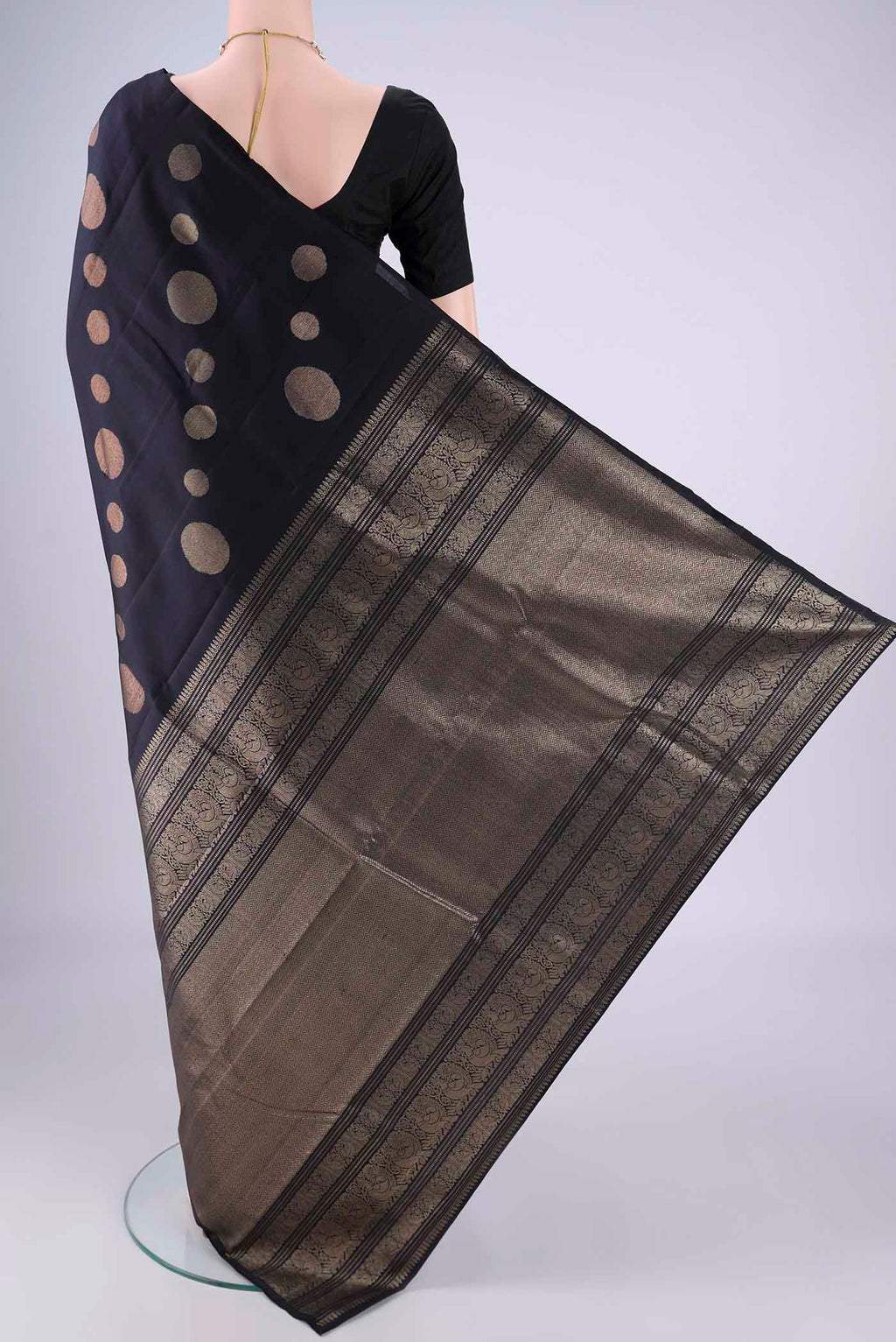Flat view of Navy Blue Soft Silk Saree with Zari Butta on the body and Without Border. 