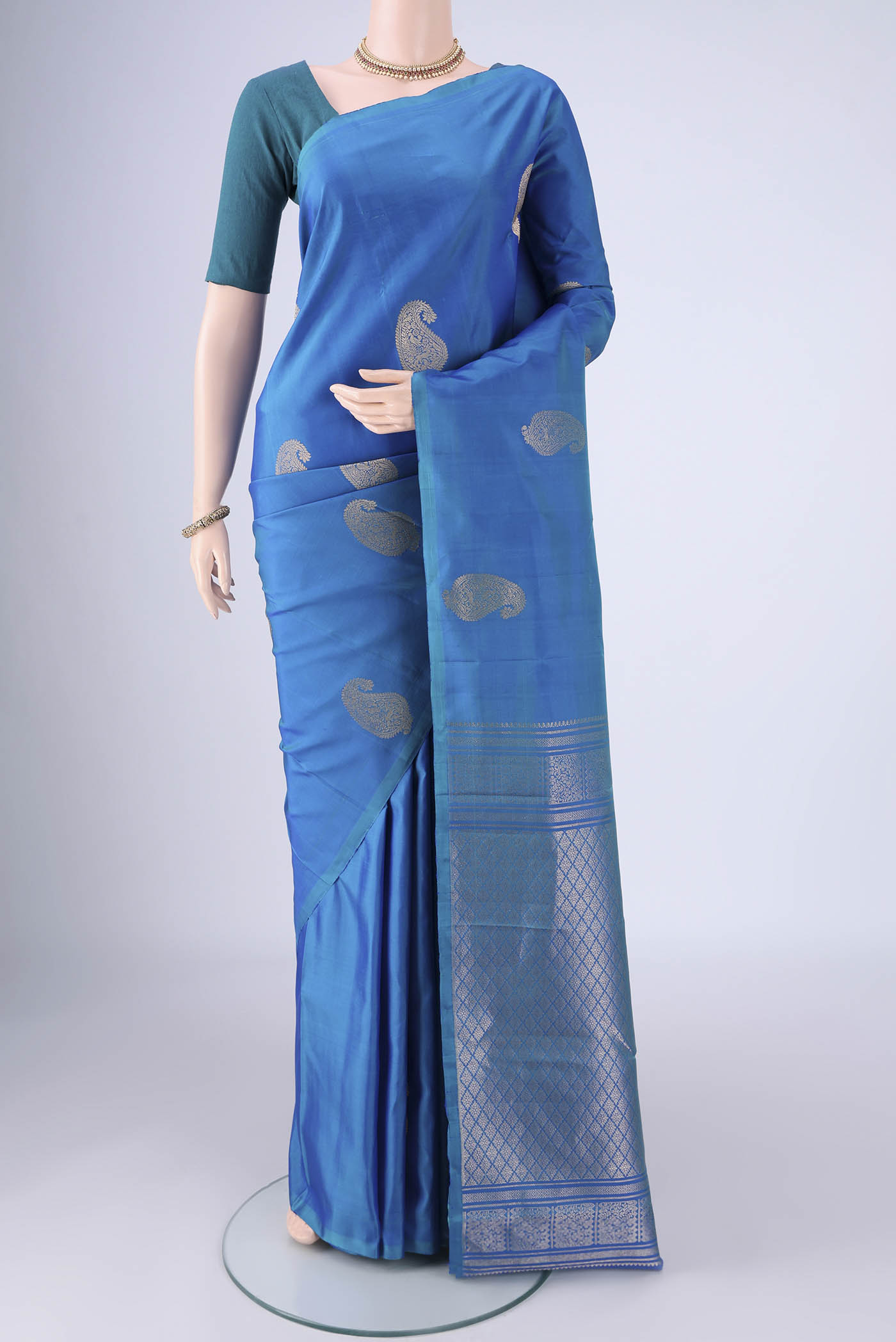 Royal Blue Soft Silk Saree with Zari Butta on the body and Without Border.  displayed on a mannequin