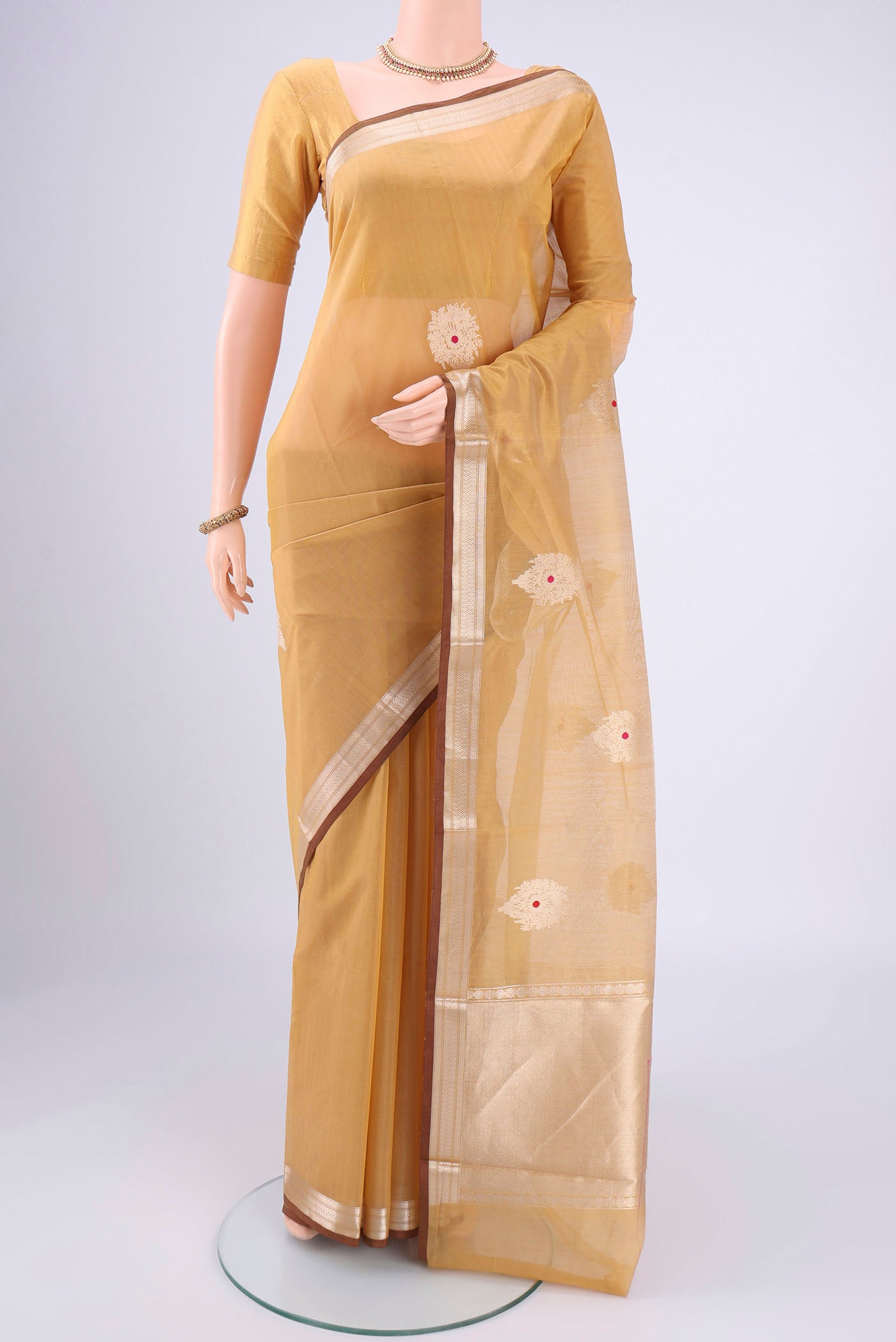 Dark Beige Chanderi Silk Cotton Saree with Zari Butta on the body and Zari Border.  displayed on a mannequin