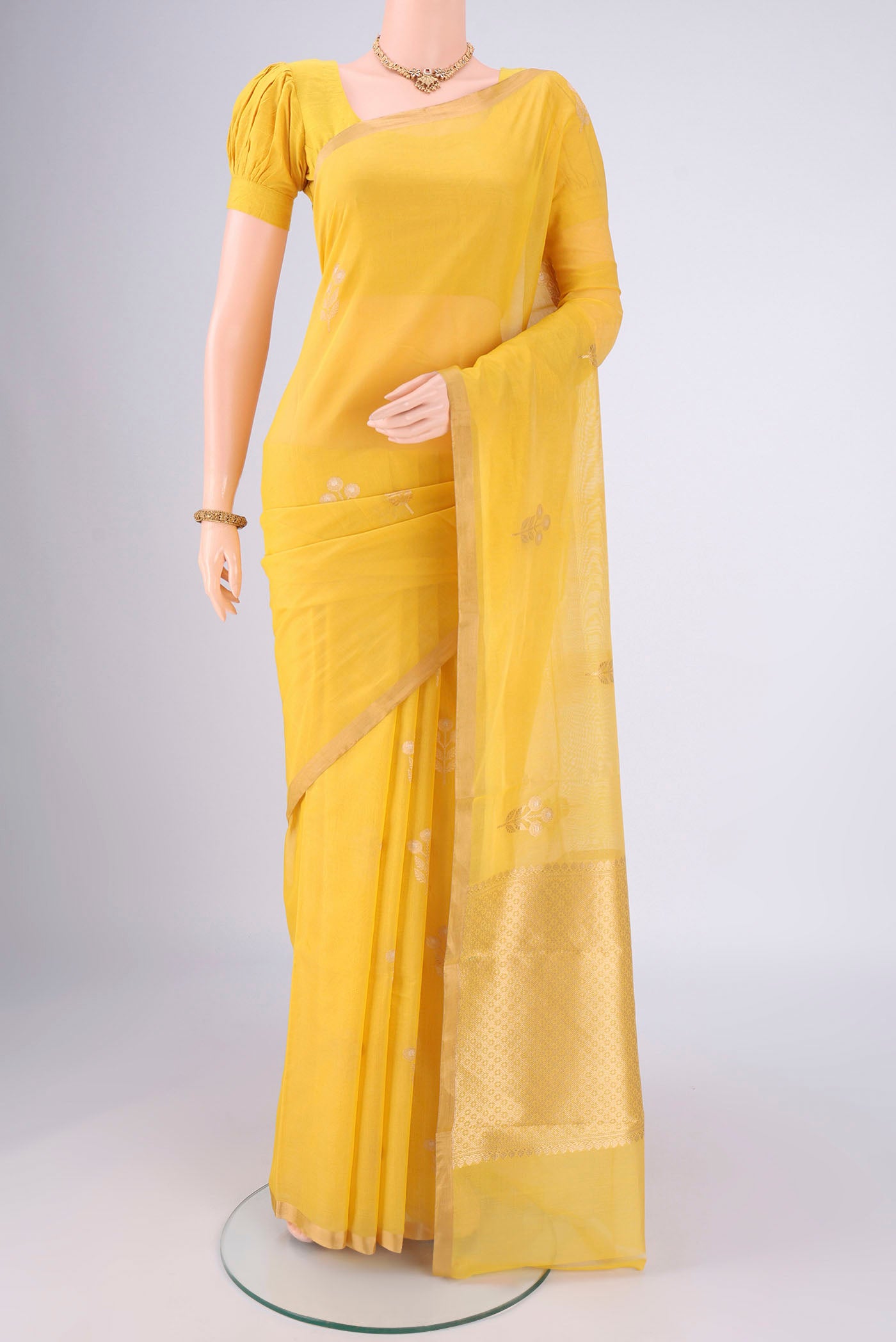 Lemon Yellow Chanderi Silk Cotton Saree with Zari Butta on the body and Zari Border.  displayed on a mannequin