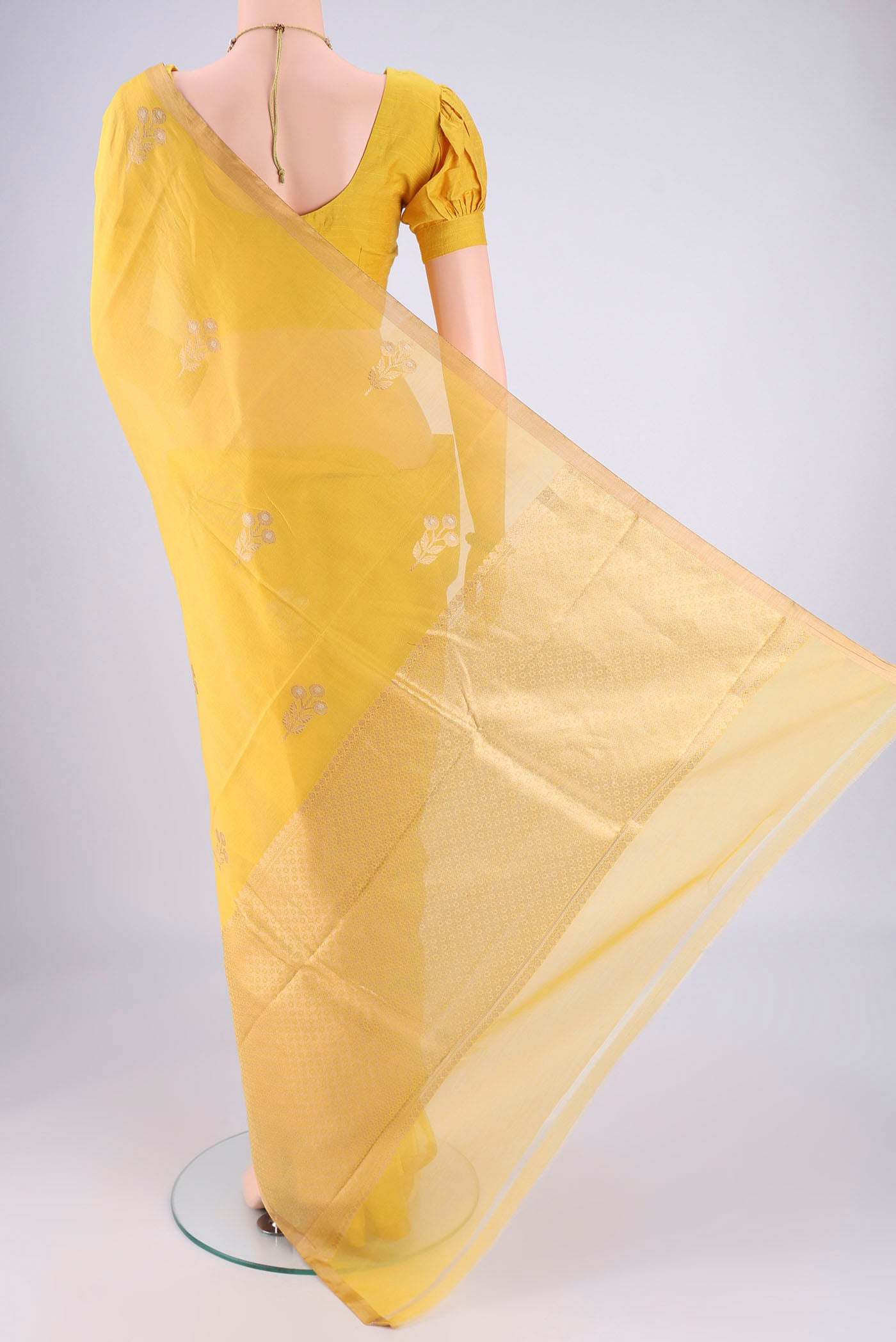 Flat view of Lemon Yellow Chanderi Silk Cotton Saree with Zari Butta on the body and Zari Border. 