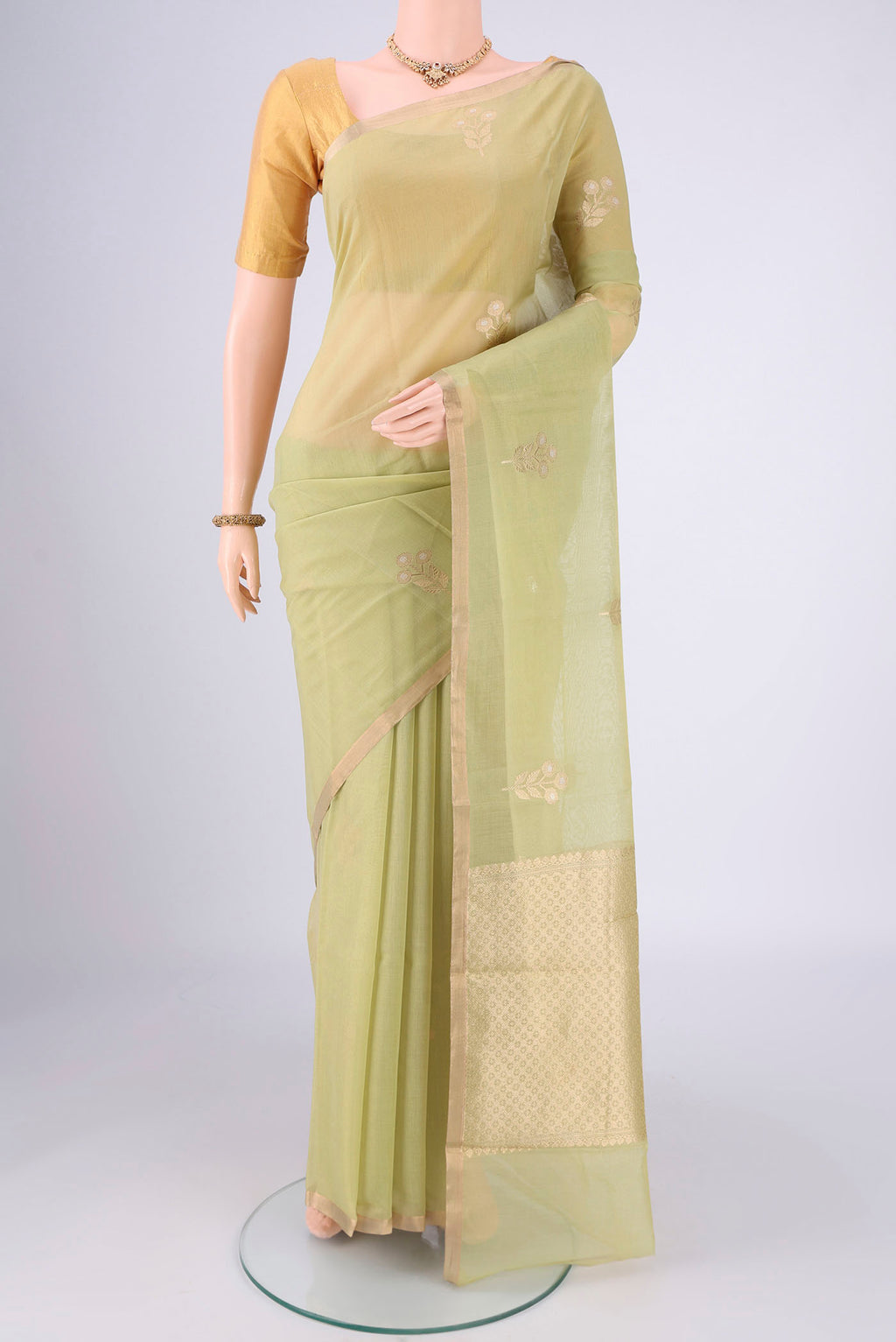 Light Green Chanderi Silk Cotton Saree with Zari Butta on the body and Zari Border.  displayed on a mannequin