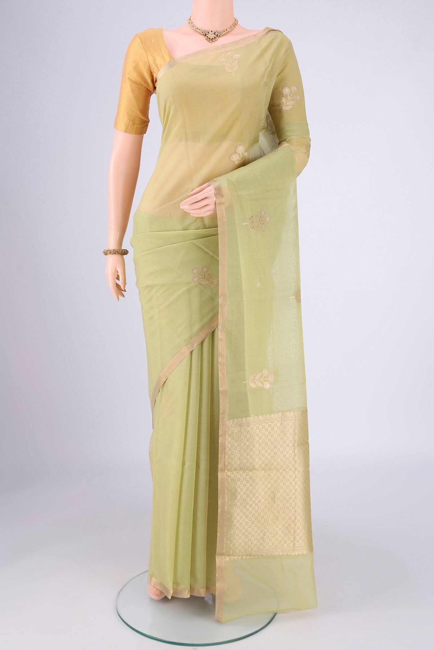 Light Green Chanderi Silk Cotton Saree with Zari Butta on the body and Zari Border.  displayed on a mannequin