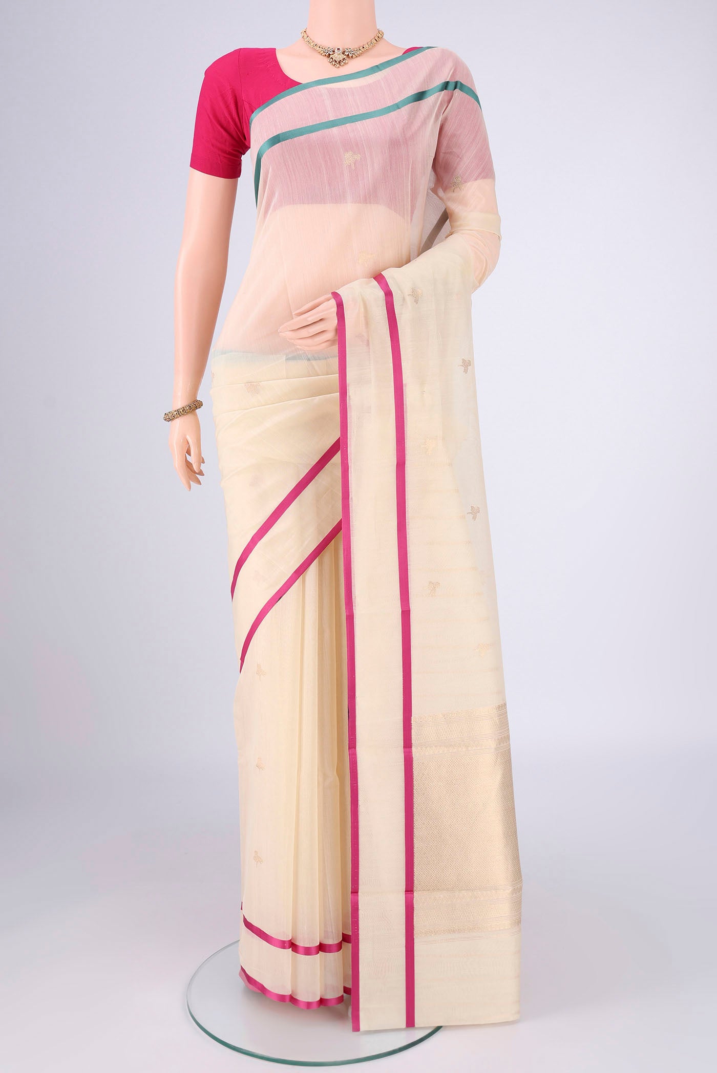 Off White Chanderi Silk Cotton Saree with Zari Butta on the body and Ganga Jamuna Border.  displayed on a mannequin