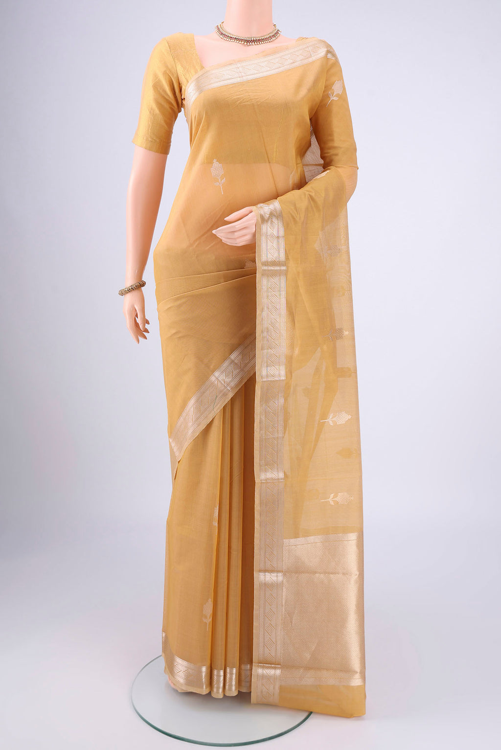 Dark Beige Chanderi Silk Cotton Saree with Zari Butta on the body and Zari Border.  displayed on a mannequin