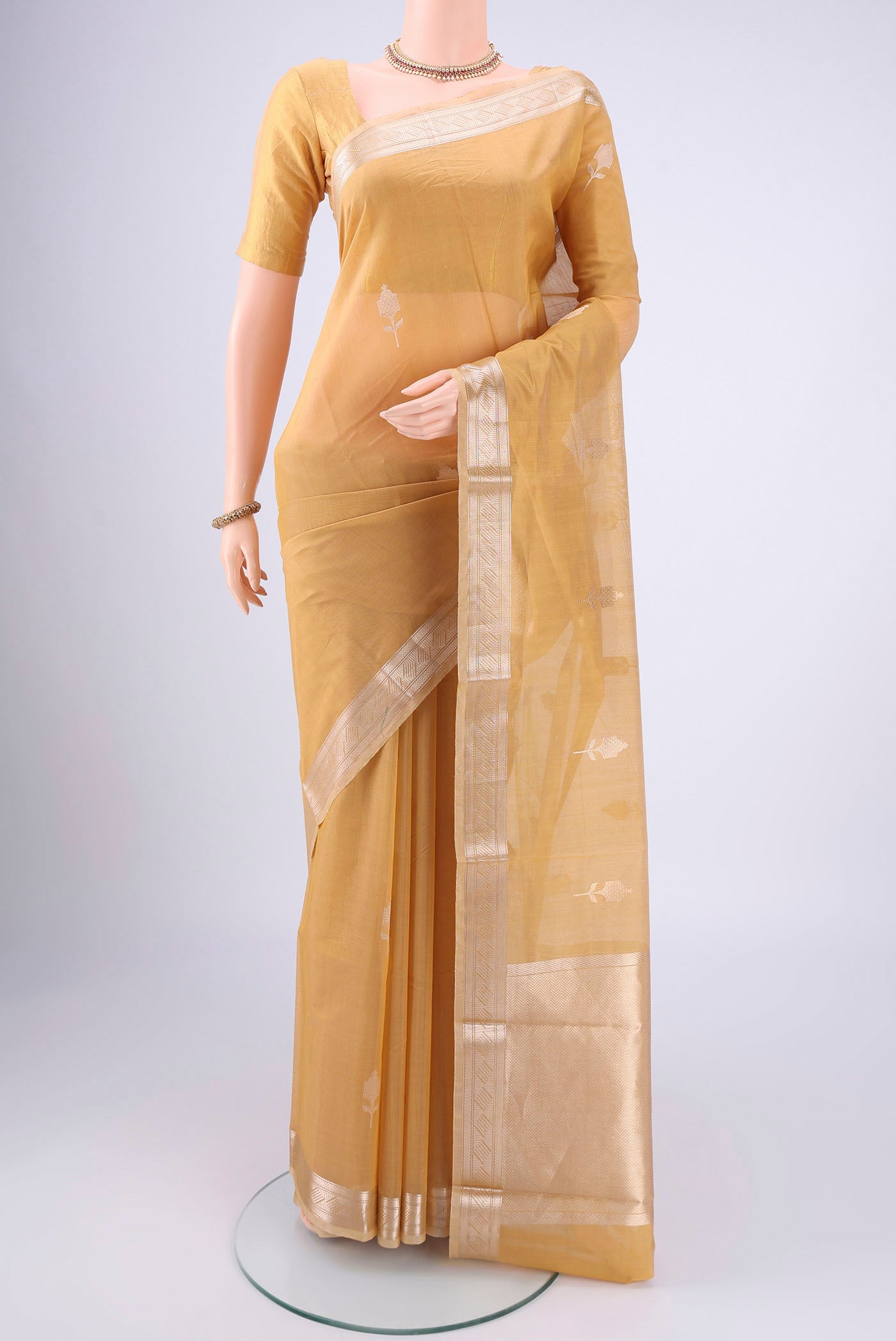 Dark Beige Chanderi Silk Cotton Saree with Zari Butta on the body and Zari Border.  displayed on a mannequin