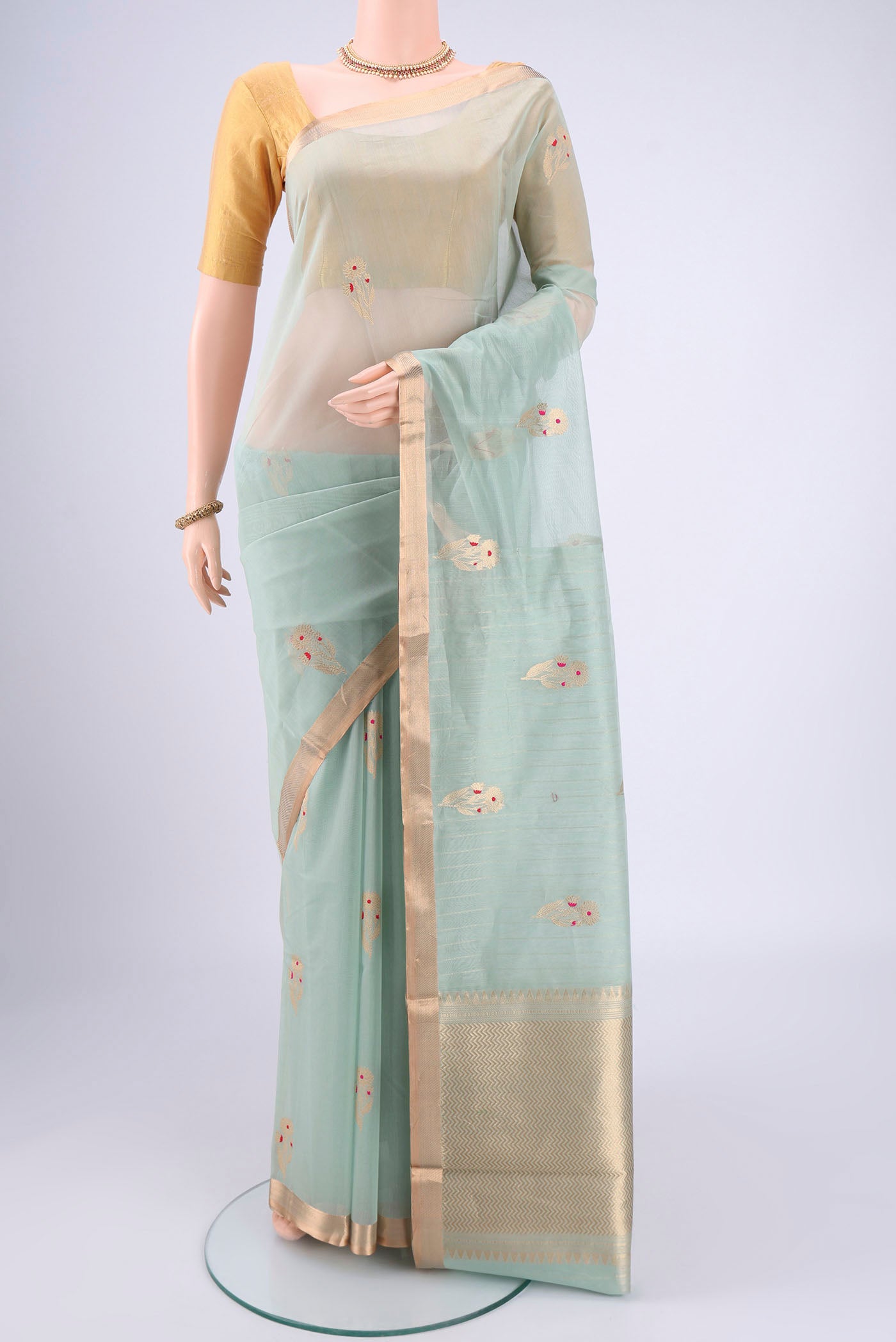 Mint Green Chanderi Silk Cotton Saree with Zari Butta on the body and Zari Border.  displayed on a mannequin