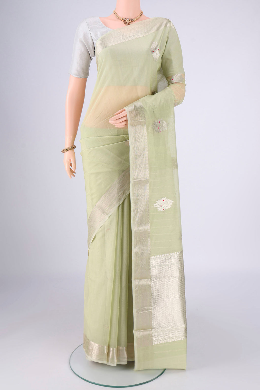 Mint Green Chanderi Silk Cotton Saree with Zari Butta on the body and Zari Border.  displayed on a mannequin