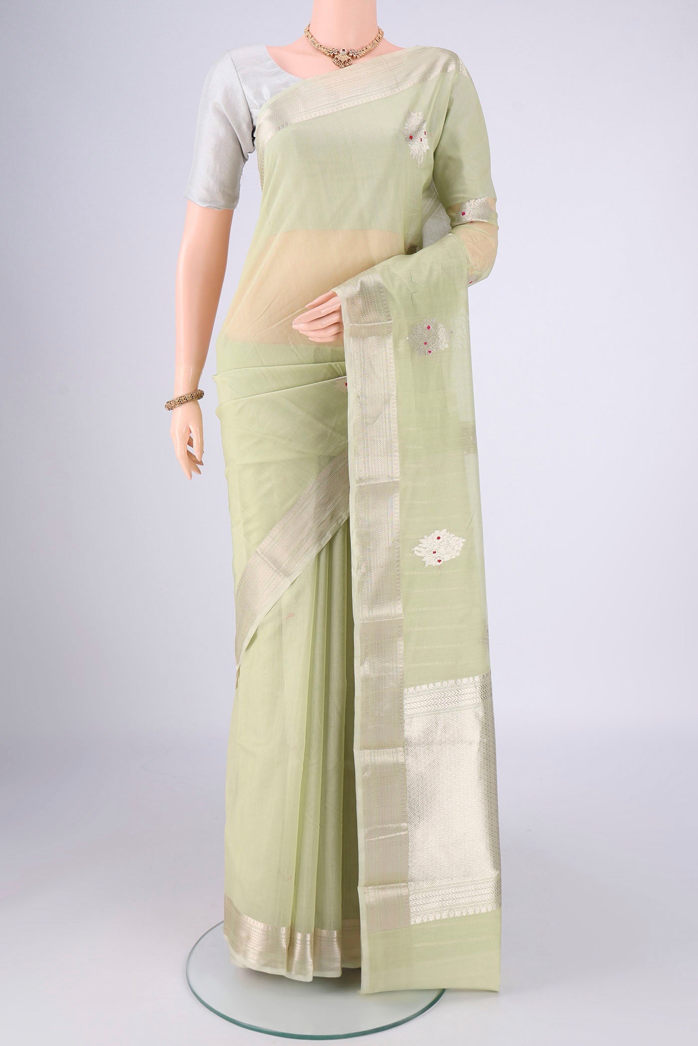 Mint Green Chanderi Silk Cotton Saree with Zari Butta on the body and Zari Border.  displayed on a mannequin