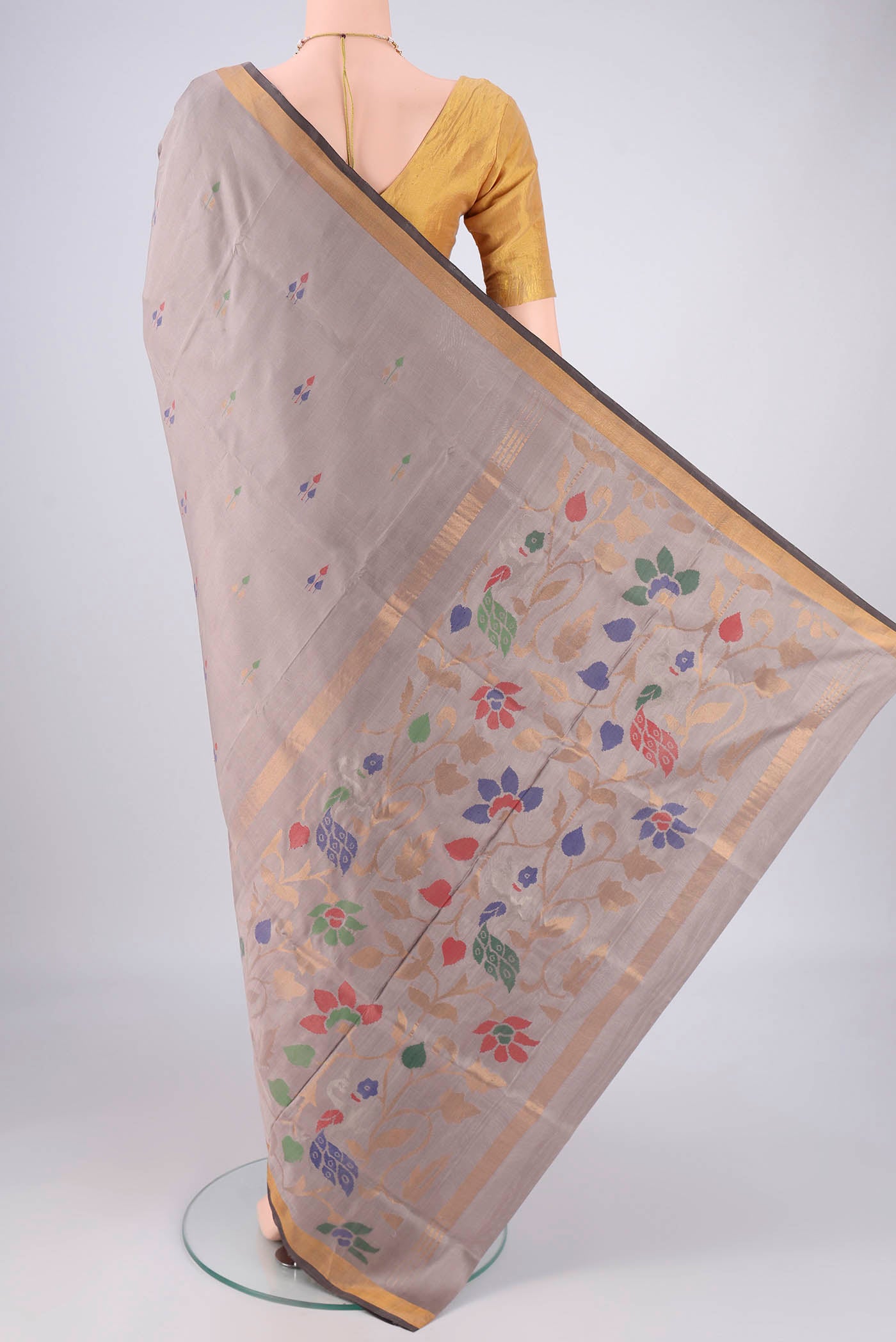 Flat view of Grey Uppada Silk Saree with Zari And Thread Butta on the body and Zari Border. 