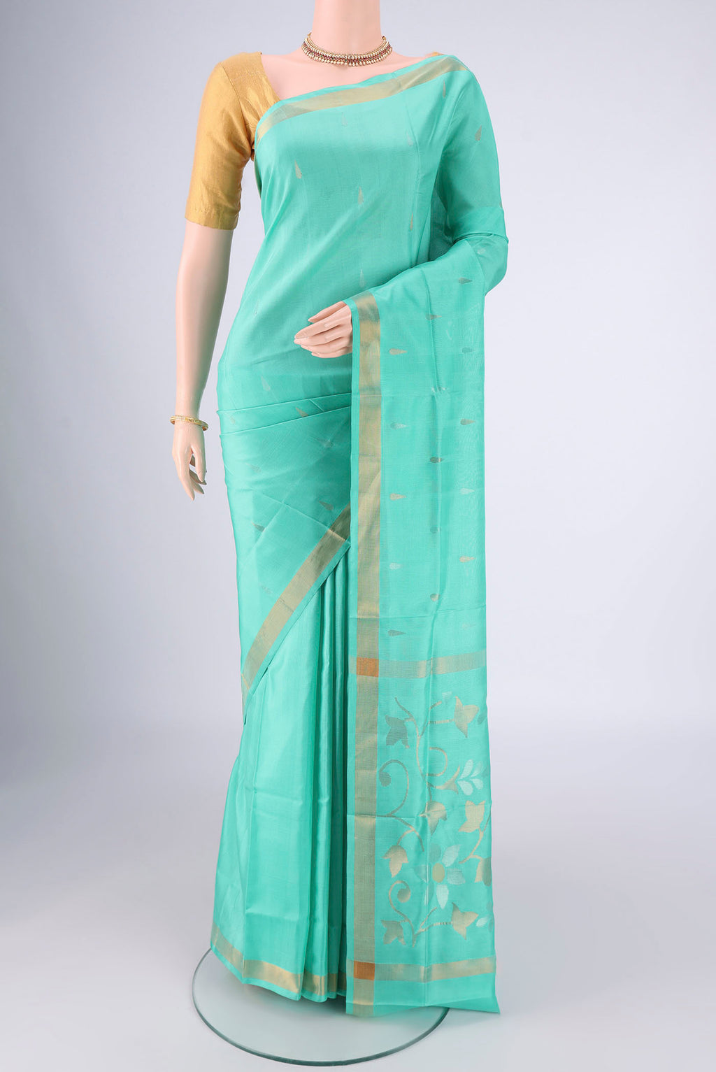 Turquoise Uppada Silk Saree with Zari Butta on the body and Zari Border.  displayed on a mannequin