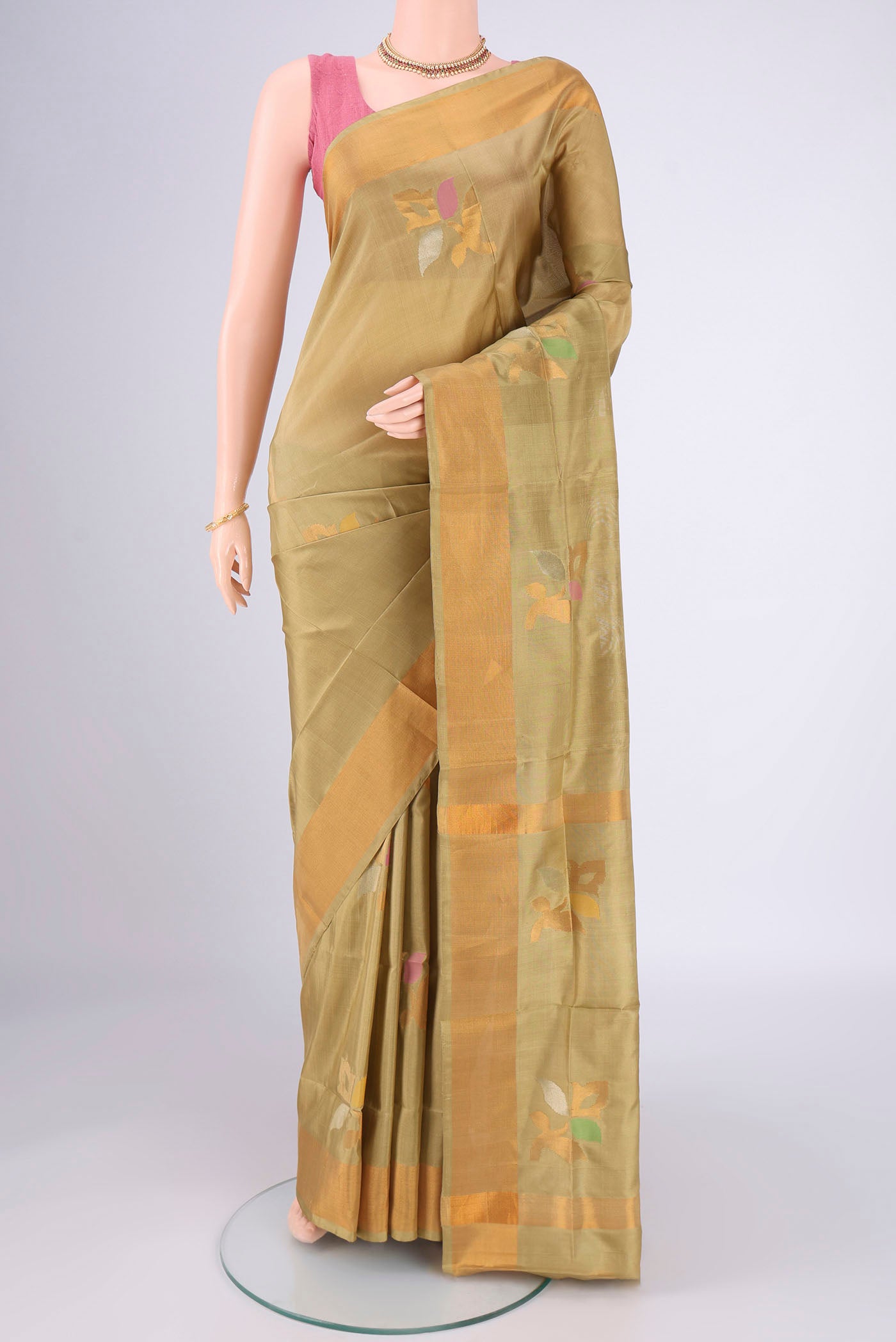 Beige Uppada Silk Saree with Zari And Thread Butta on the body and Zari Border.  displayed on a mannequin