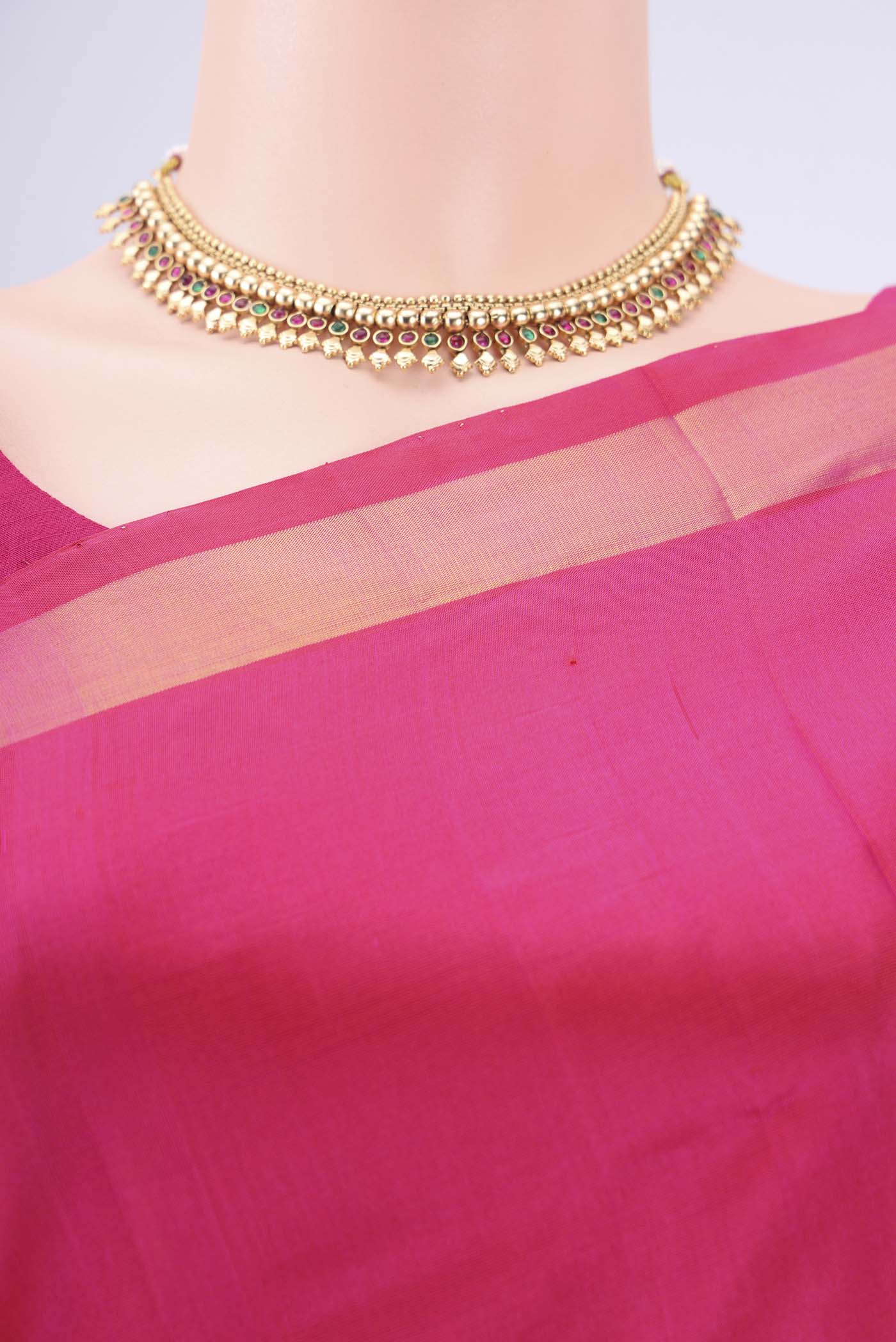 Border image of Rani Pink Uppada Silk Saree with Zari Butta on the body and Zari Border. 