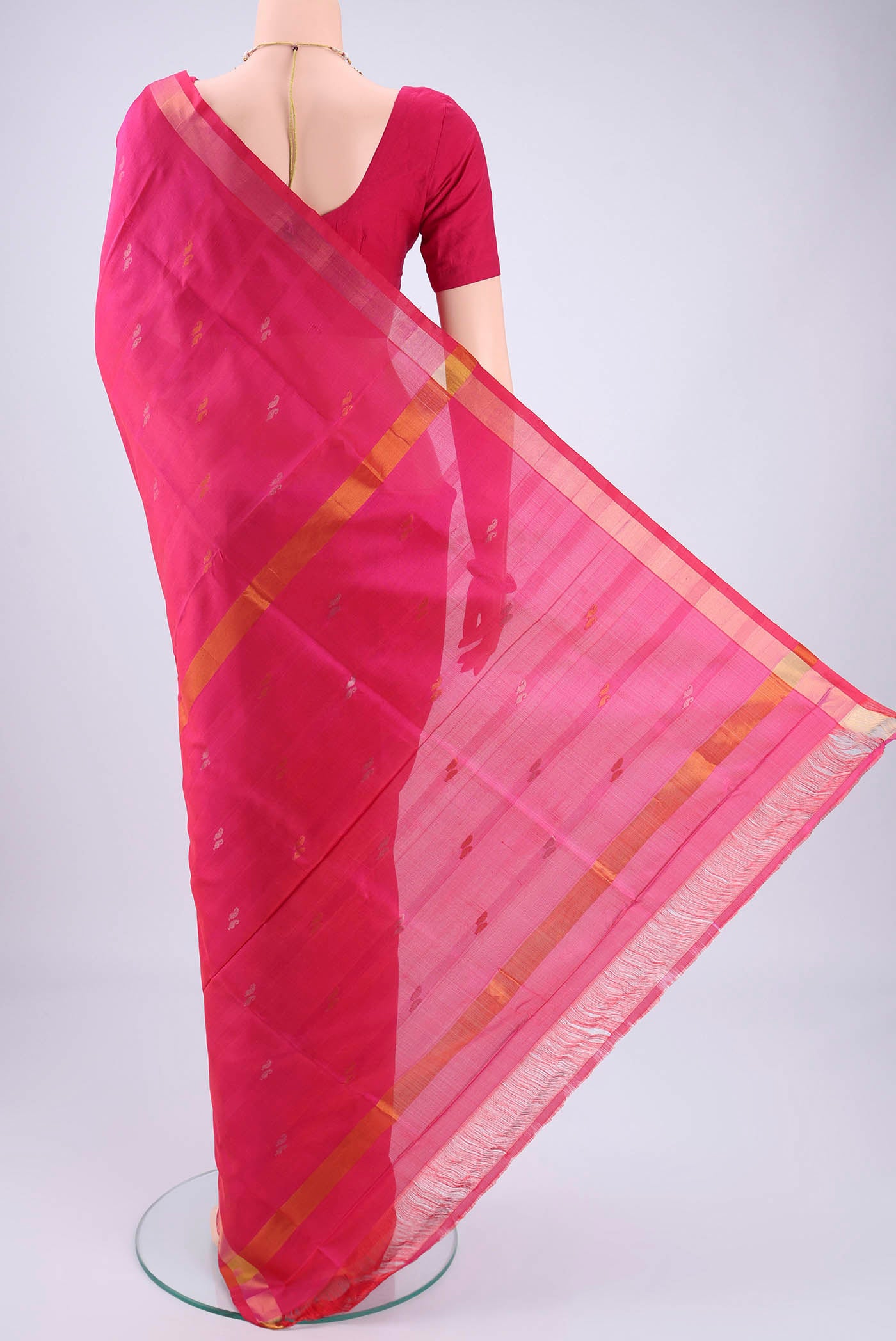 Flat view of Rani Pink Uppada Silk Saree with Zari Butta on the body and Zari Border. 